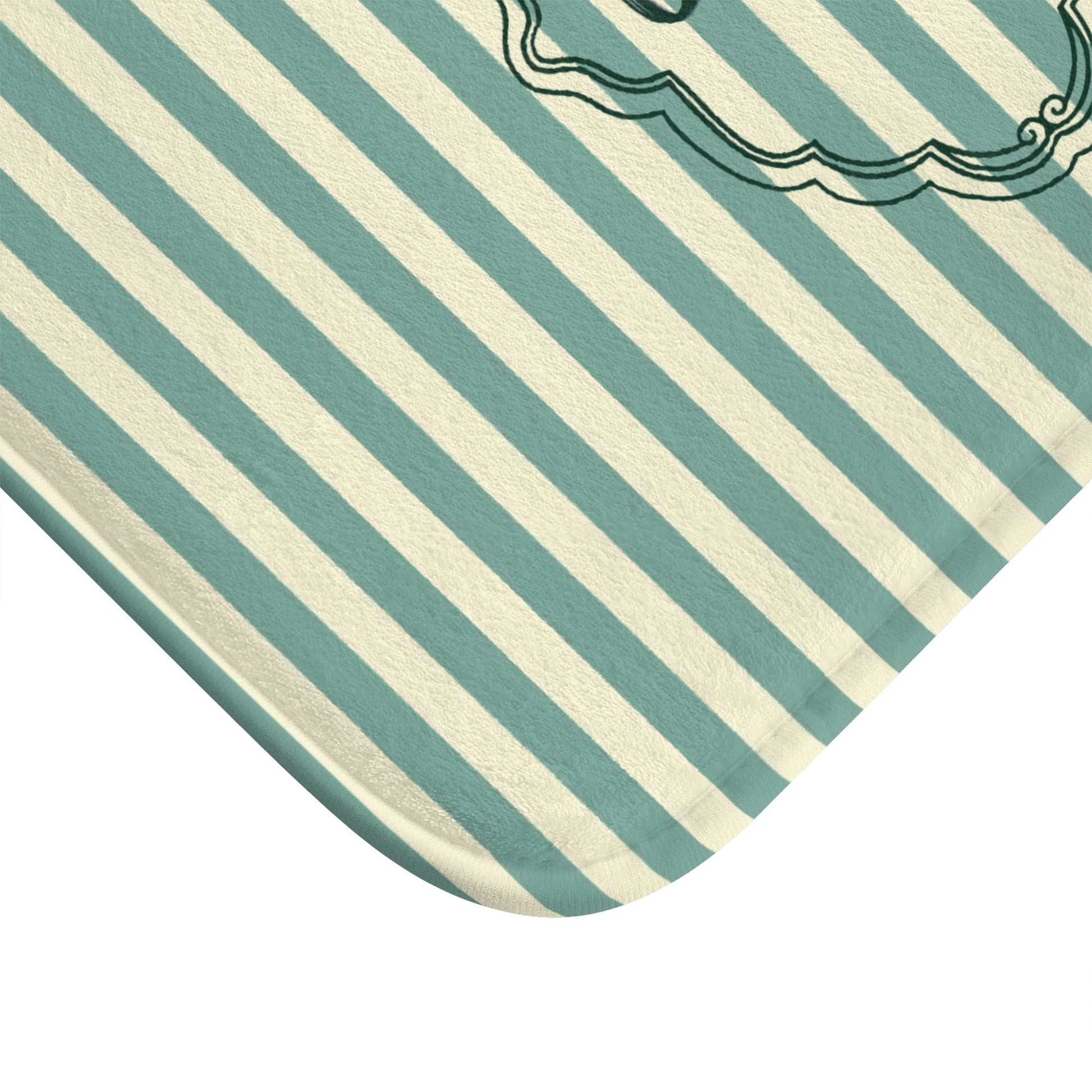 Close-up of a green and white striped fabric with a decorative border.