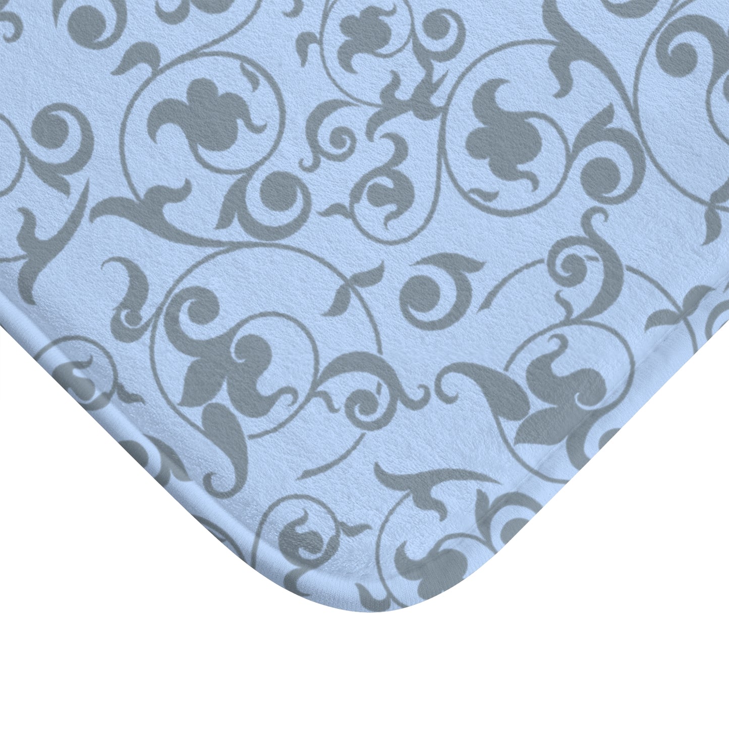Patterned fabric with swirling designs on a light blue background