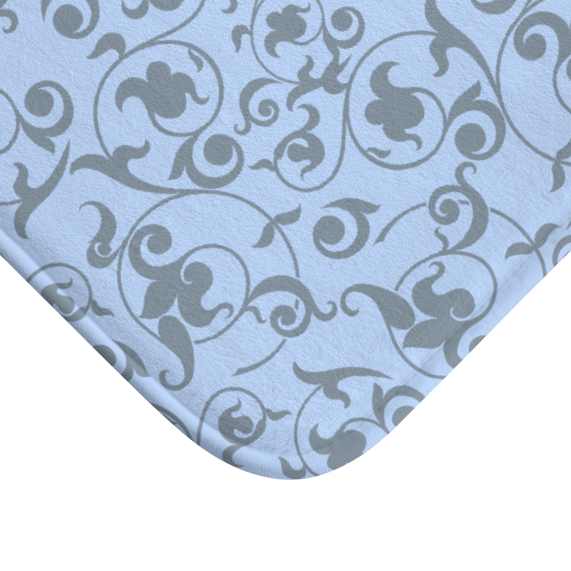 Patterned fabric with swirling designs on a light blue background