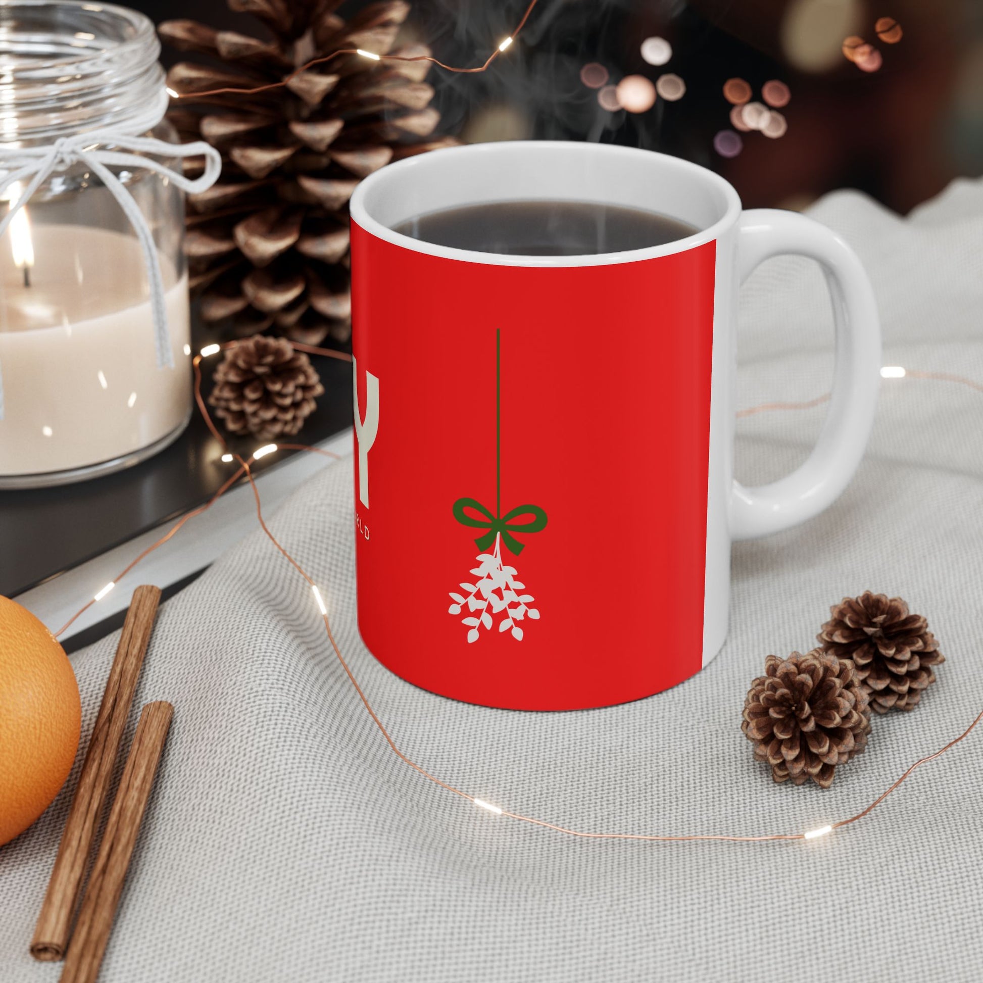 Red mug with a Christmas design on a table with decorative items