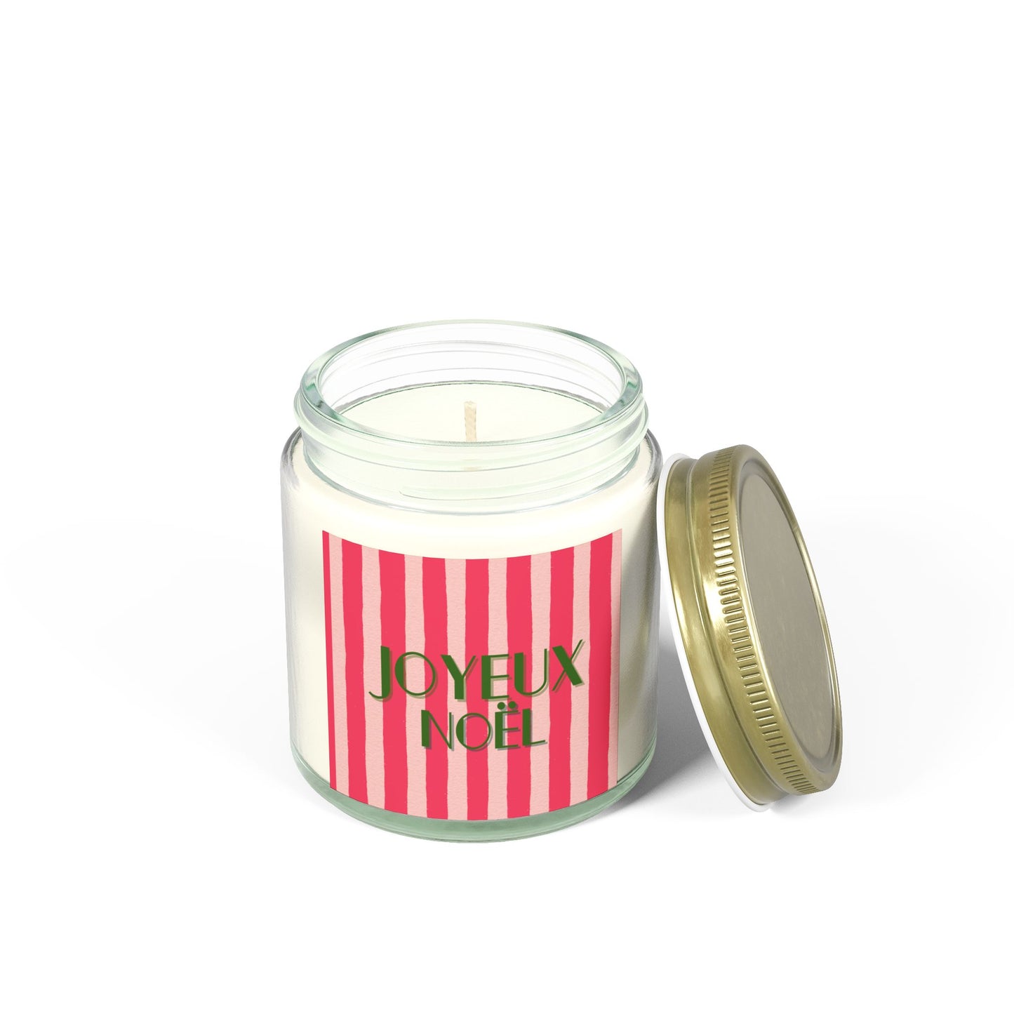 Joyeux Noel Candle in a glass jar with a red and white striped label and gold lid on a white background