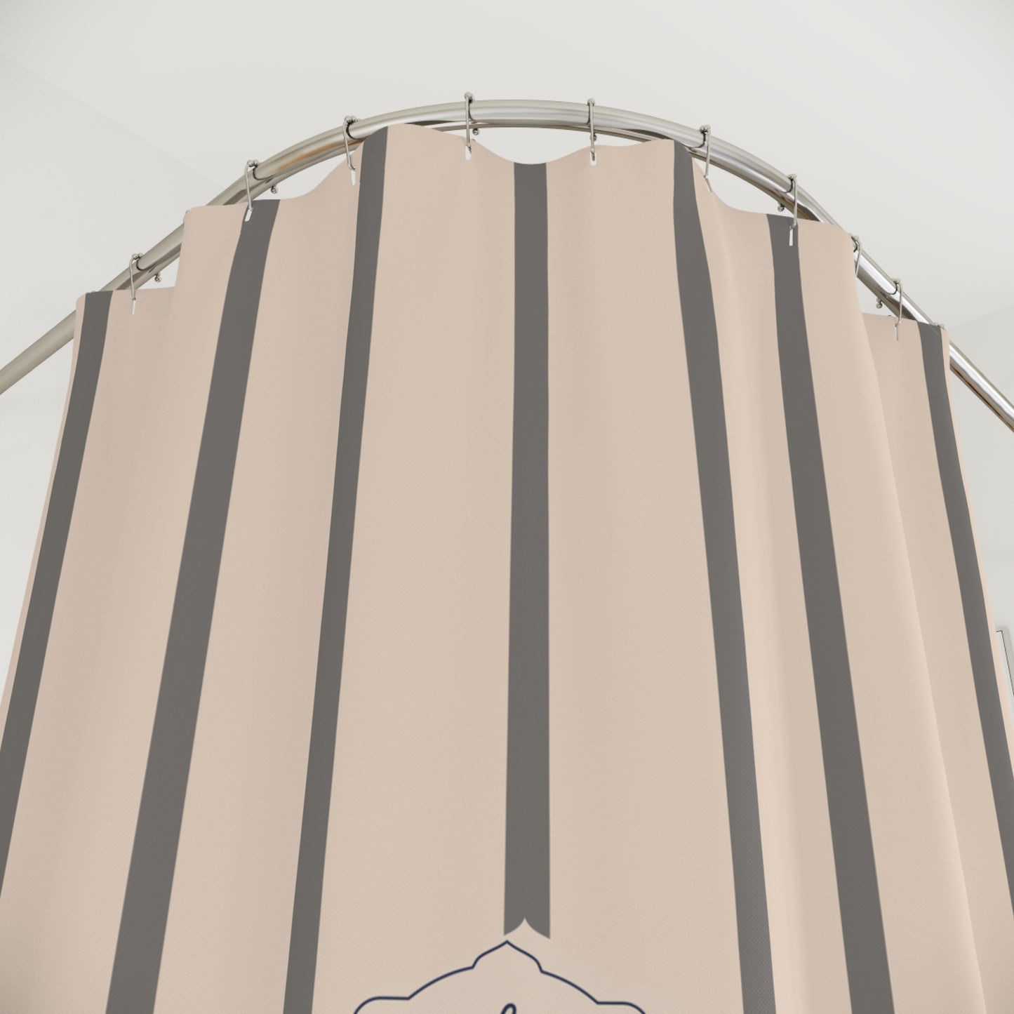 Beige and gray striped shower curtain on a metal rod against a white background