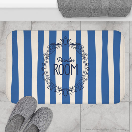 Striped bath mat with 'Powder Room' text on a bathroom floor.
