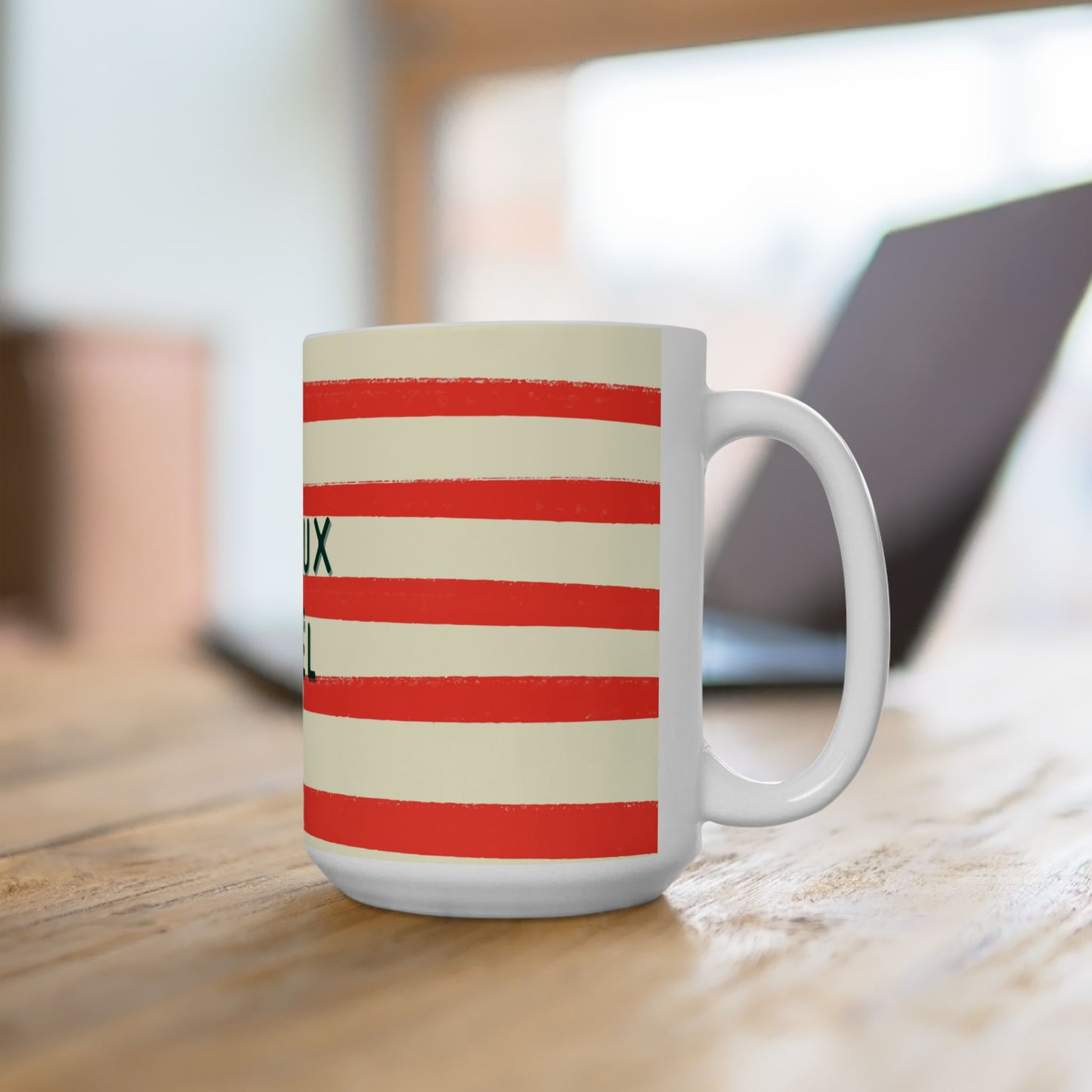 White mug with red and beige stripes on a wooden surface