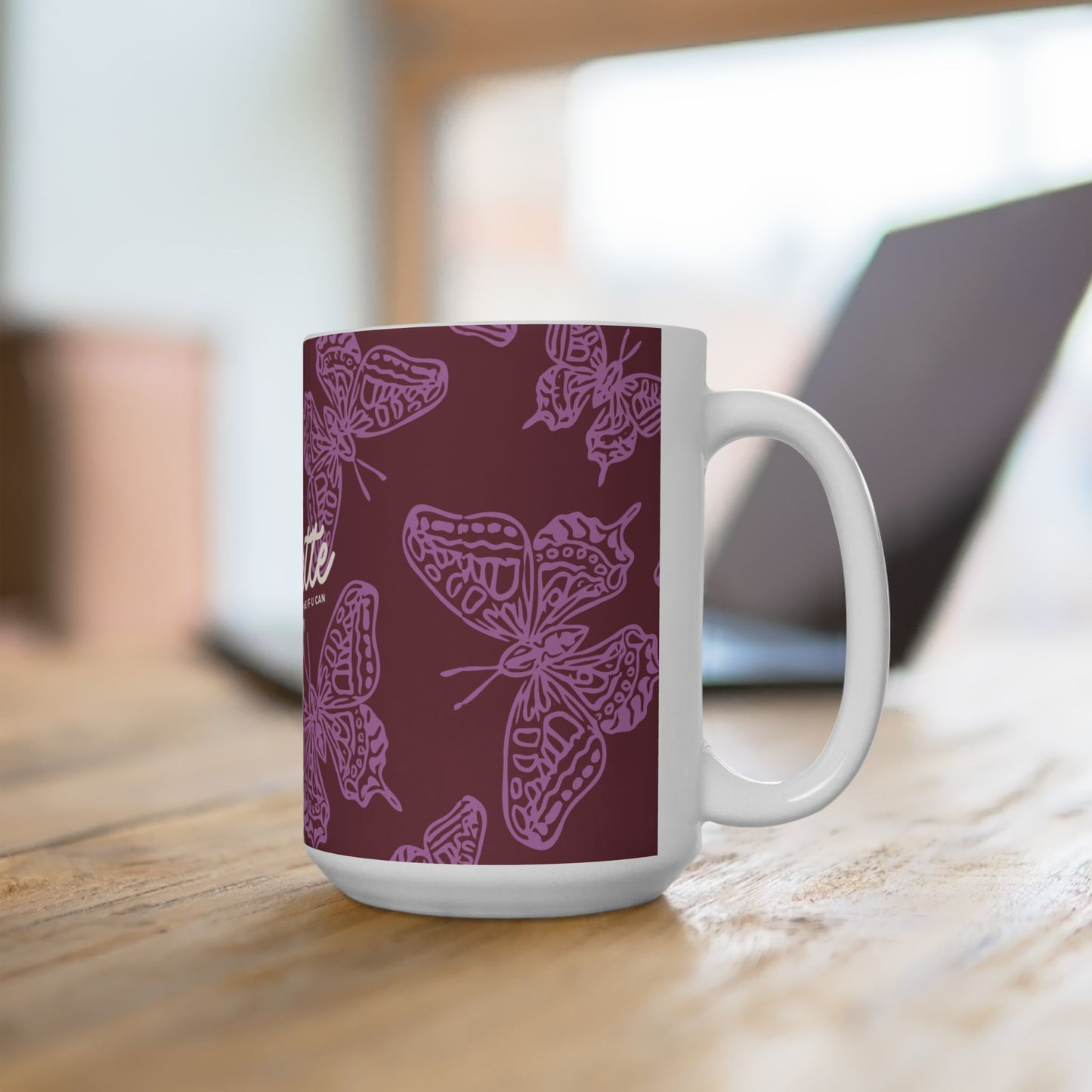 White mug with purple butterfly pattern on a wooden surface