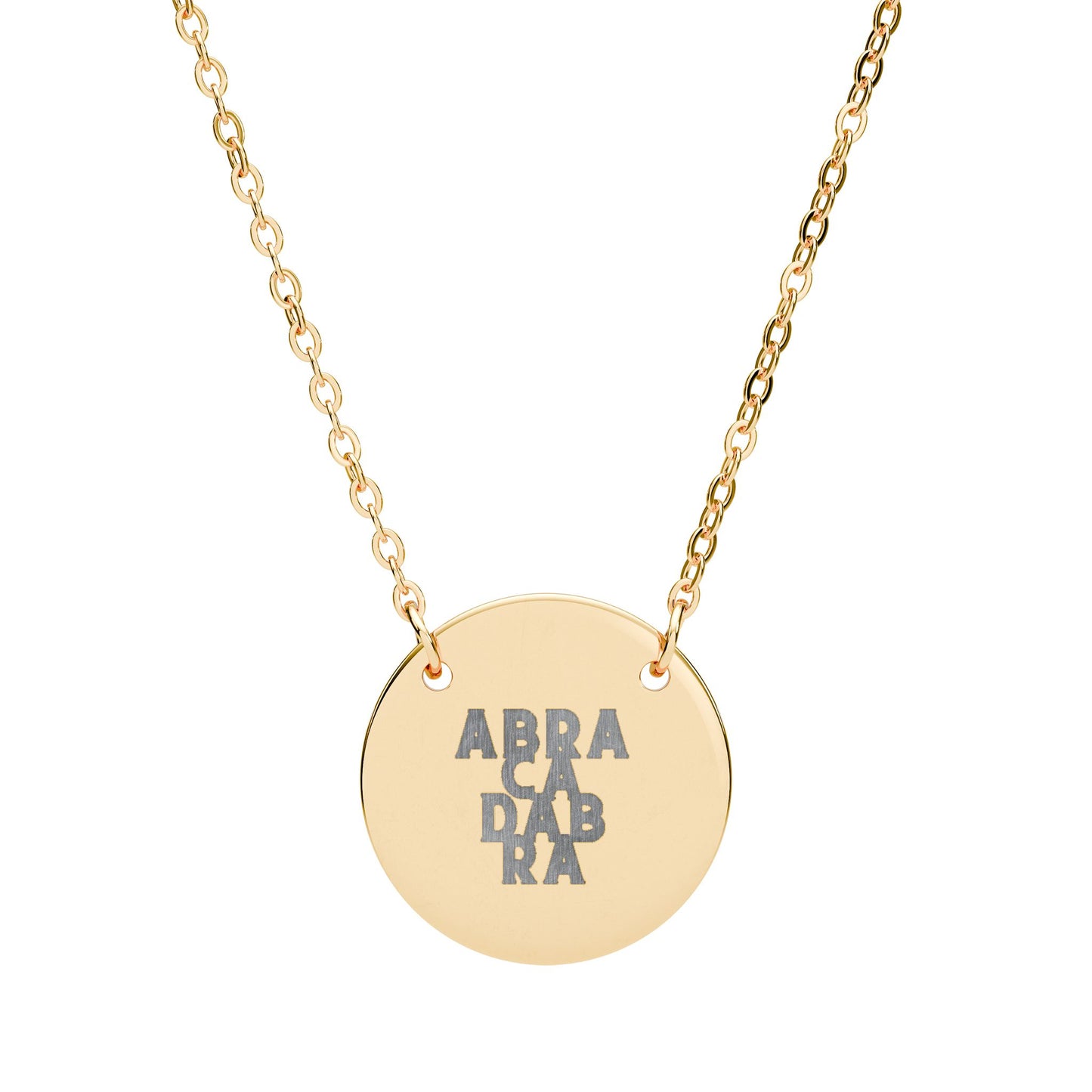 Gold necklace with a round pendant featuring 'ABRACADABRA' on a white background
