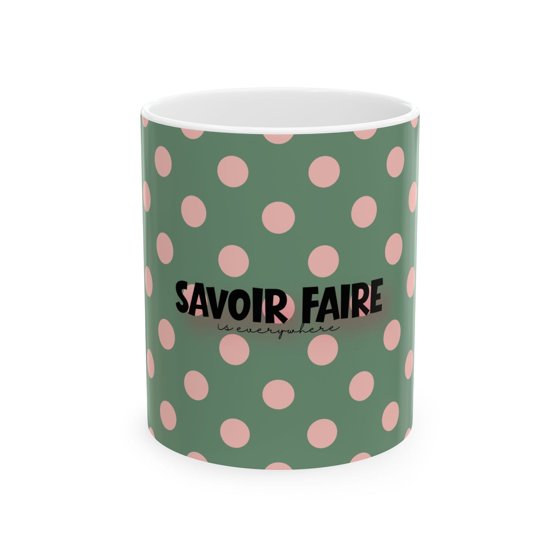 Green mug with pink polka dots and 'Savoir Faire' text on a white background