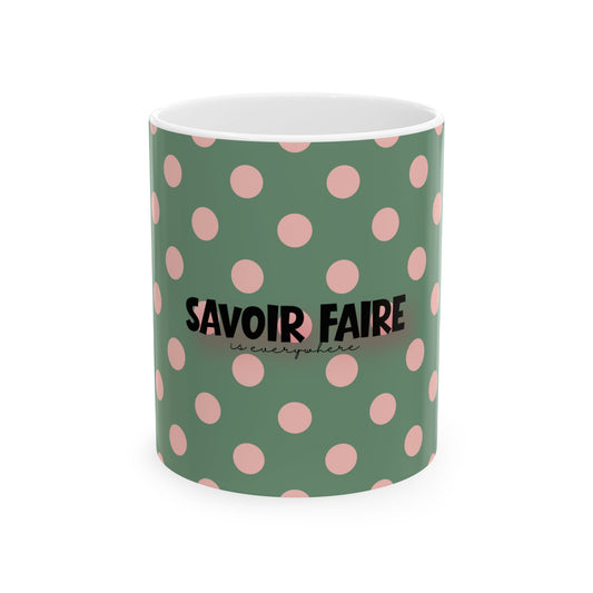 Green mug with pink polka dots and 'Savoir Faire' text on a white background