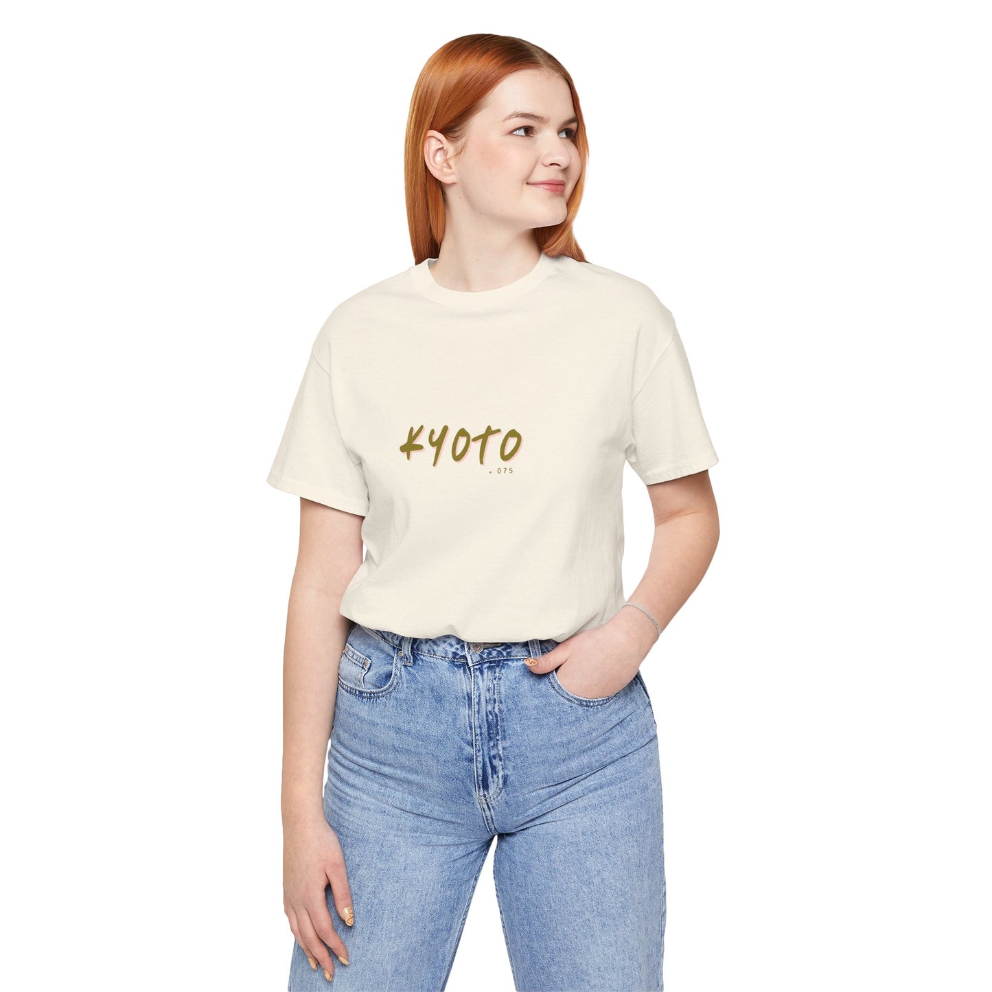 Person wearing a cream t-shirt with 'KYOTO' printed on it, standing against a white background