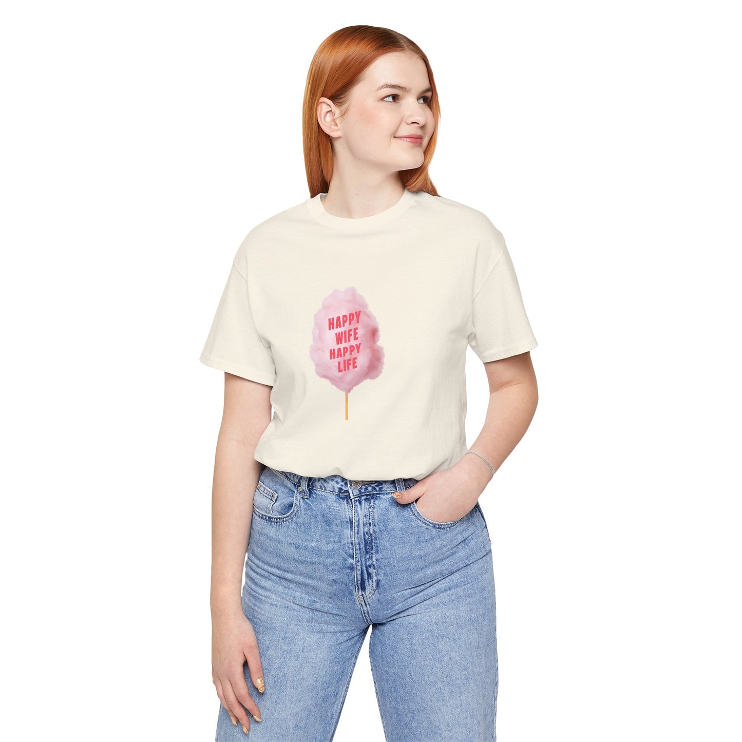 A woman with red hair wearing a white short-sleeve t-shirt with a pink cotton candy graphic on the front, paired with light blue jeans, against a plain white background.