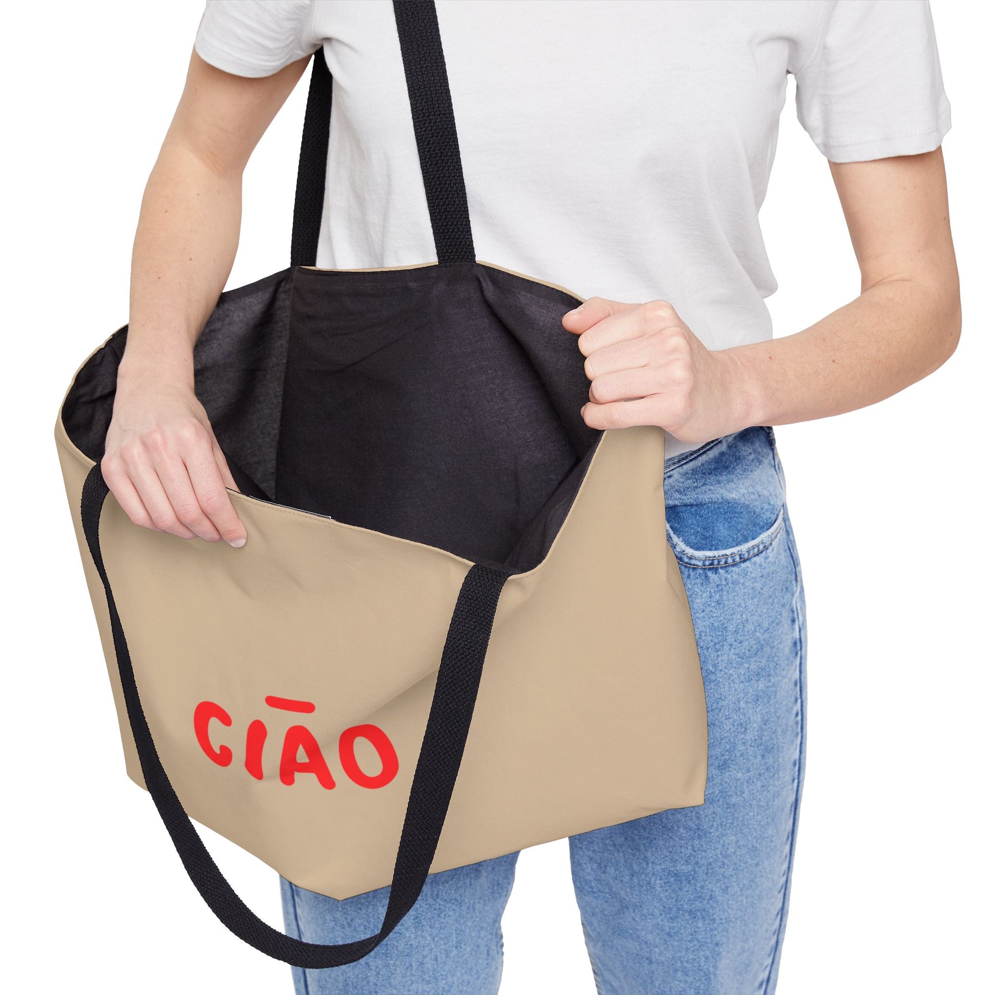 Person holding a two-toned bag with 'CIAO' written on it against a white background