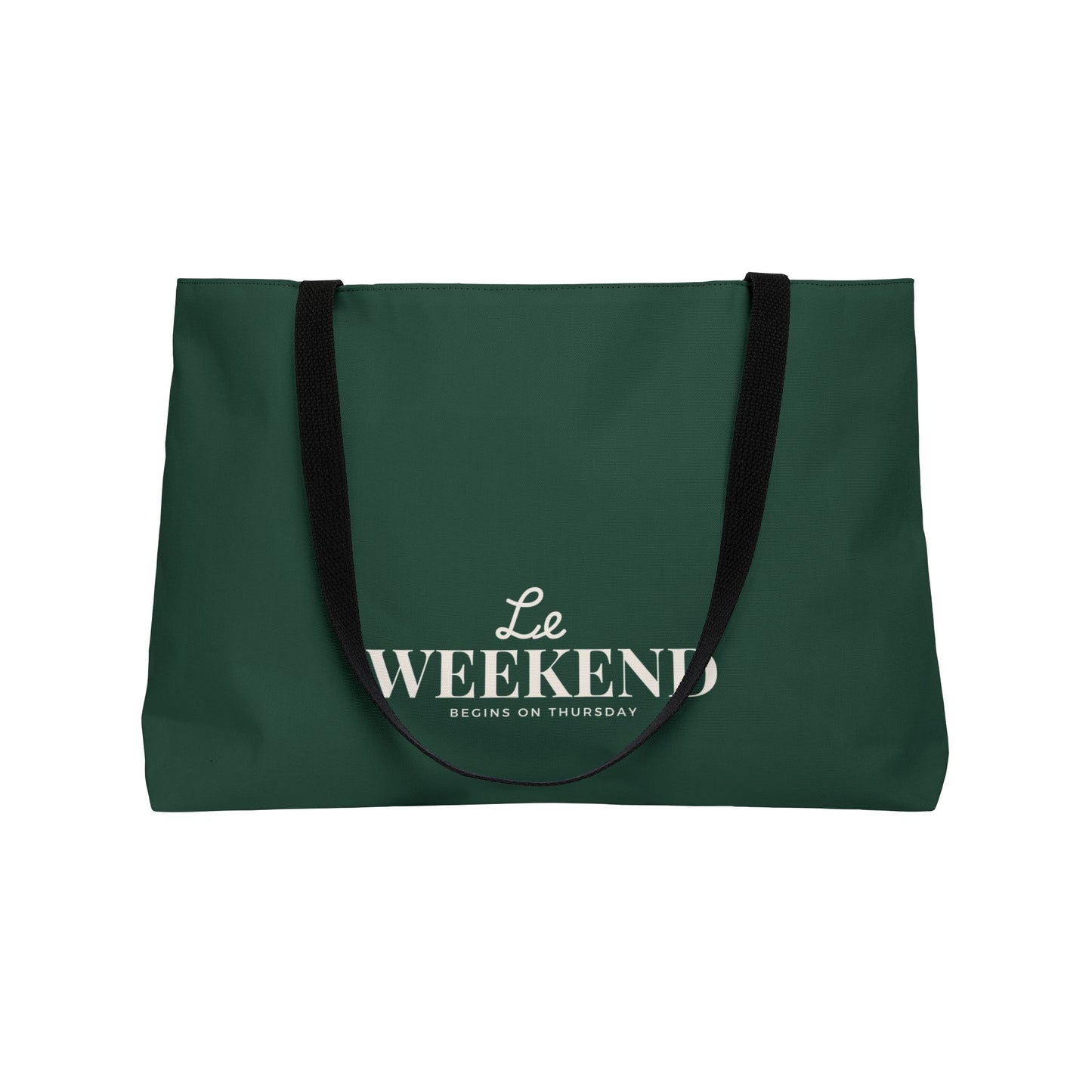 Green tote bag with 'Le Weekend Begins on Thursday' text on a white background