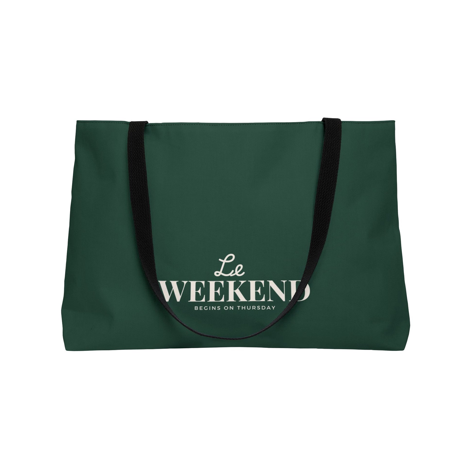 Green tote bag with 'Le Weekend Begins on Thursday' text on a white background