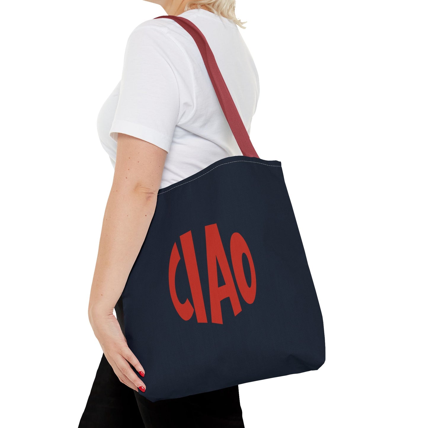 Person holding a navy tote bag with red 'CIAO' text on a white background
