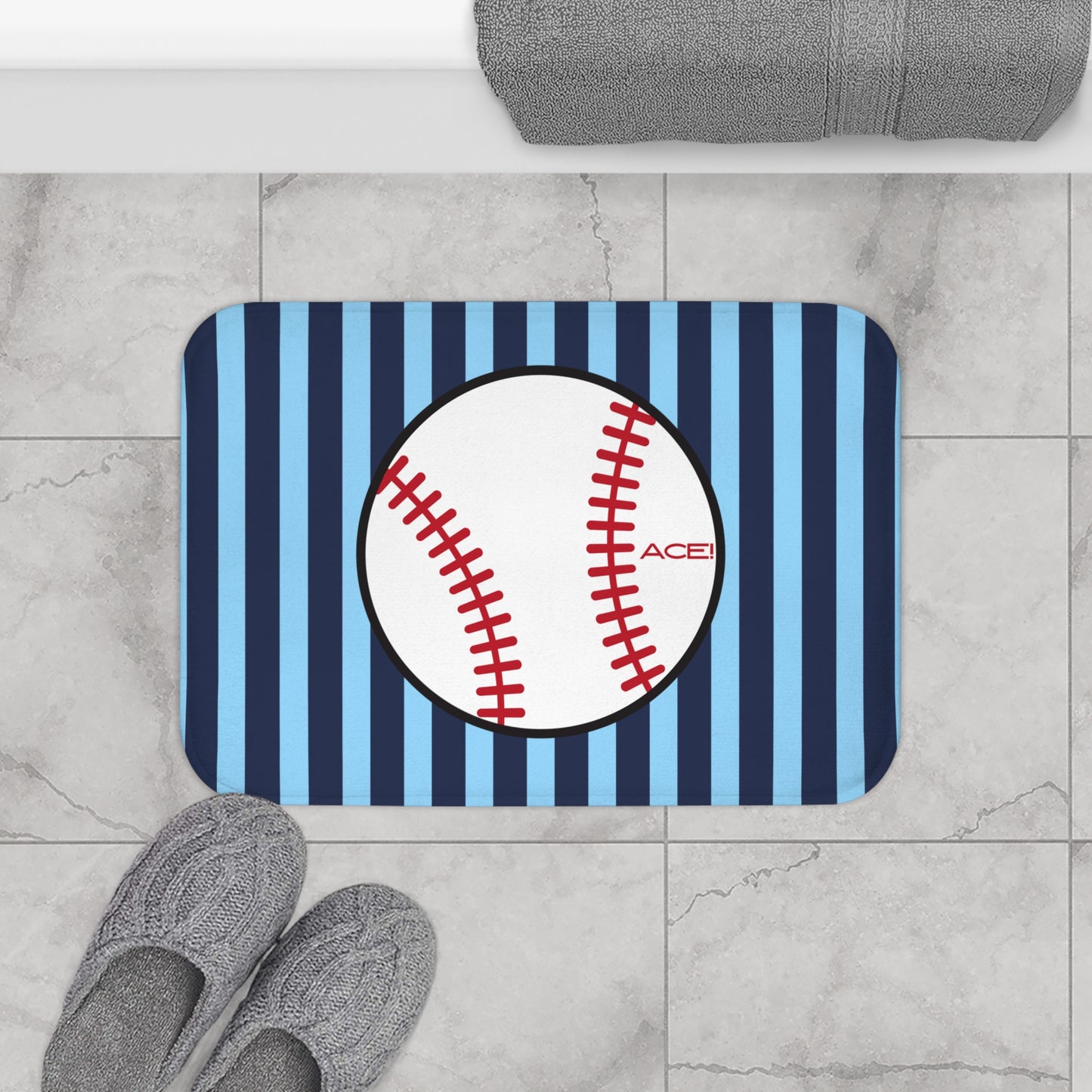 Doormat with baseball design on a striped background, placed on a tiled floor.