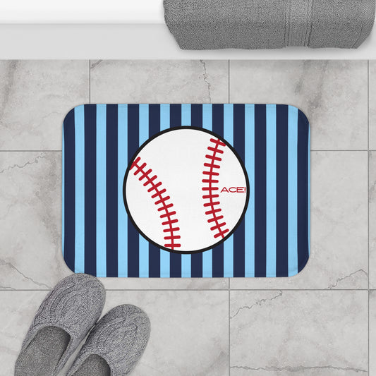 Doormat with baseball design on a striped background, placed on a tiled floor.