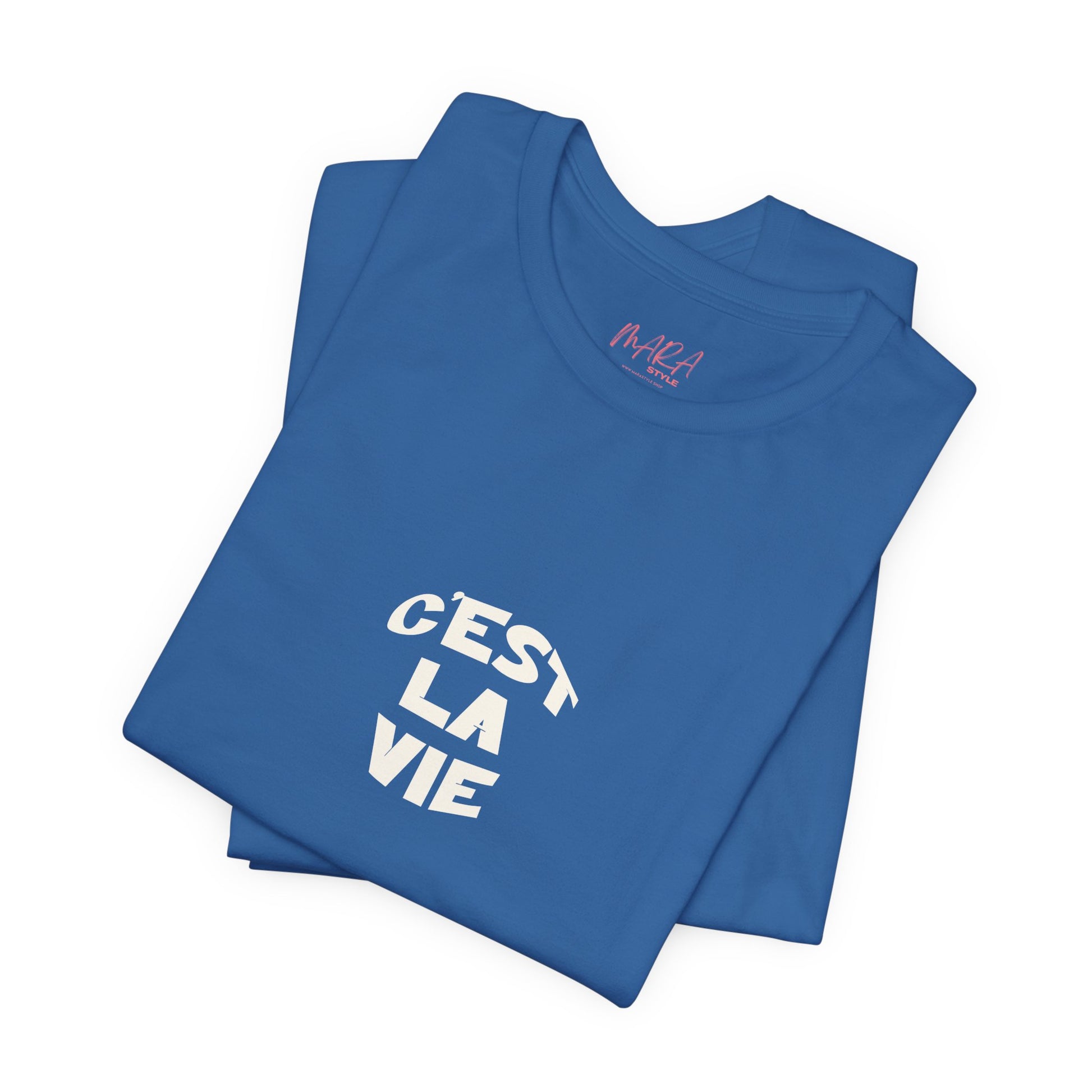 Folded blue t-shirt with 'C'est La Vie' text on a white background