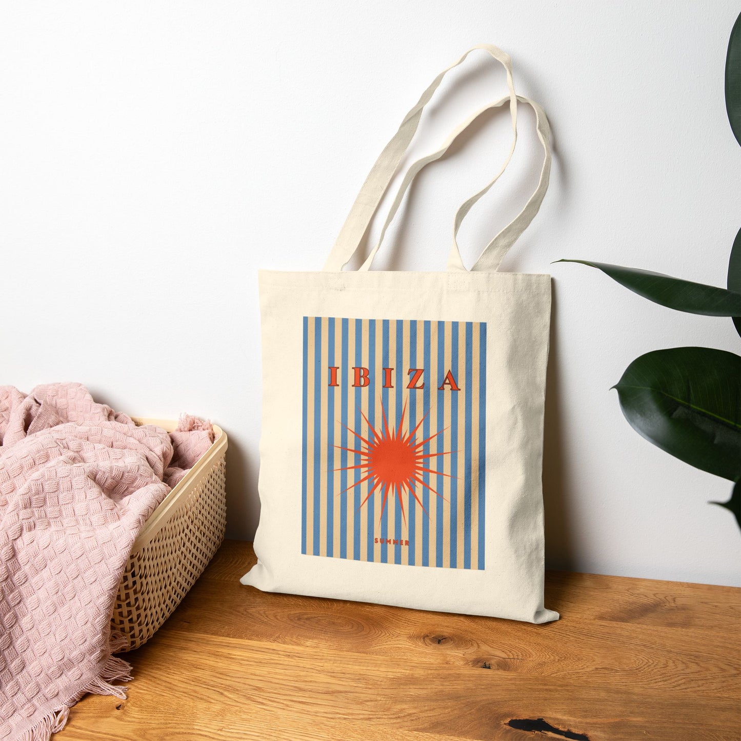 Tote bag with 'Ibiza' design on a wooden surface with a white wall background
