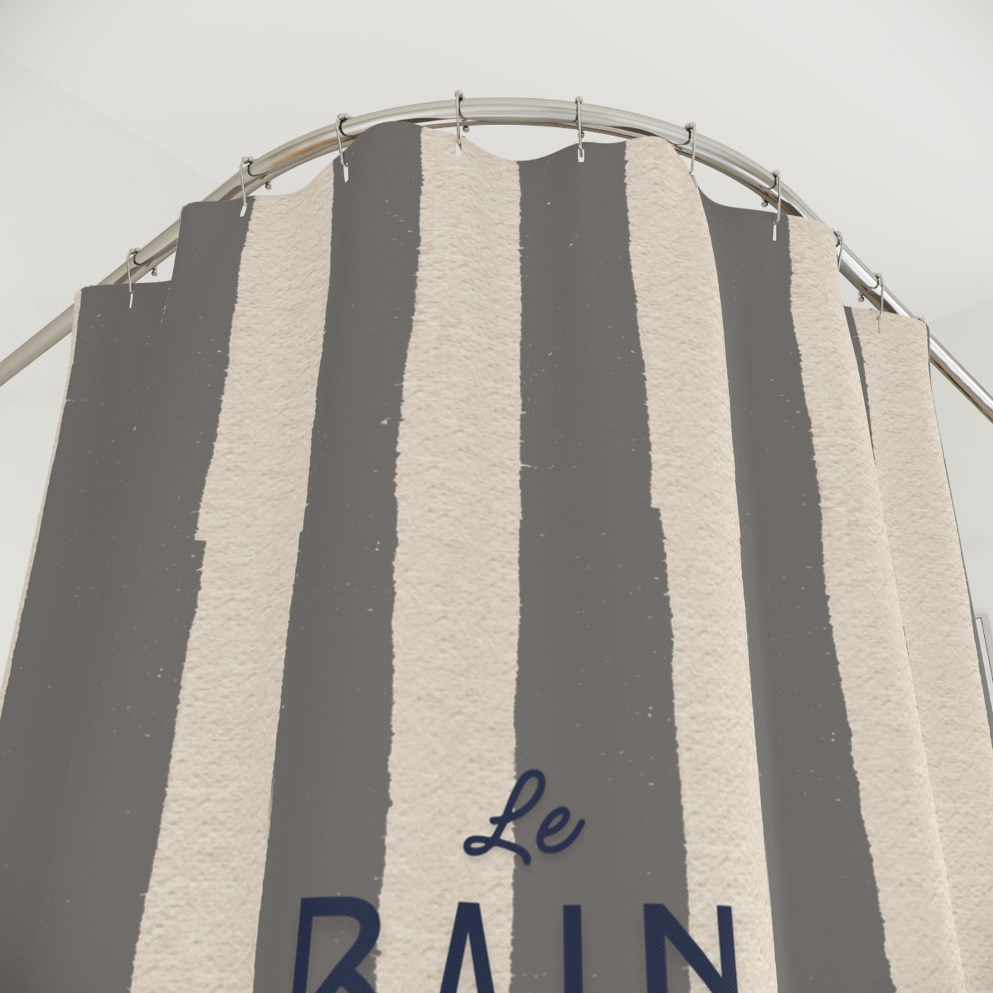 Striped shower curtain with 'Le Rain' branding on a gray background
