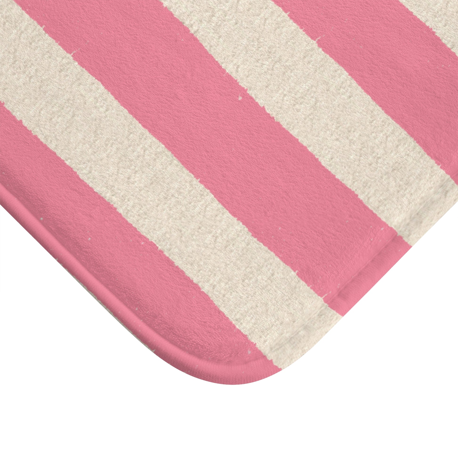 Close-up of a pink and white striped bath mat