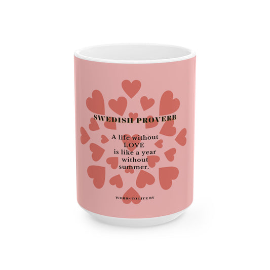 Pink mug with heart designs and a Swedish proverb on a white background
