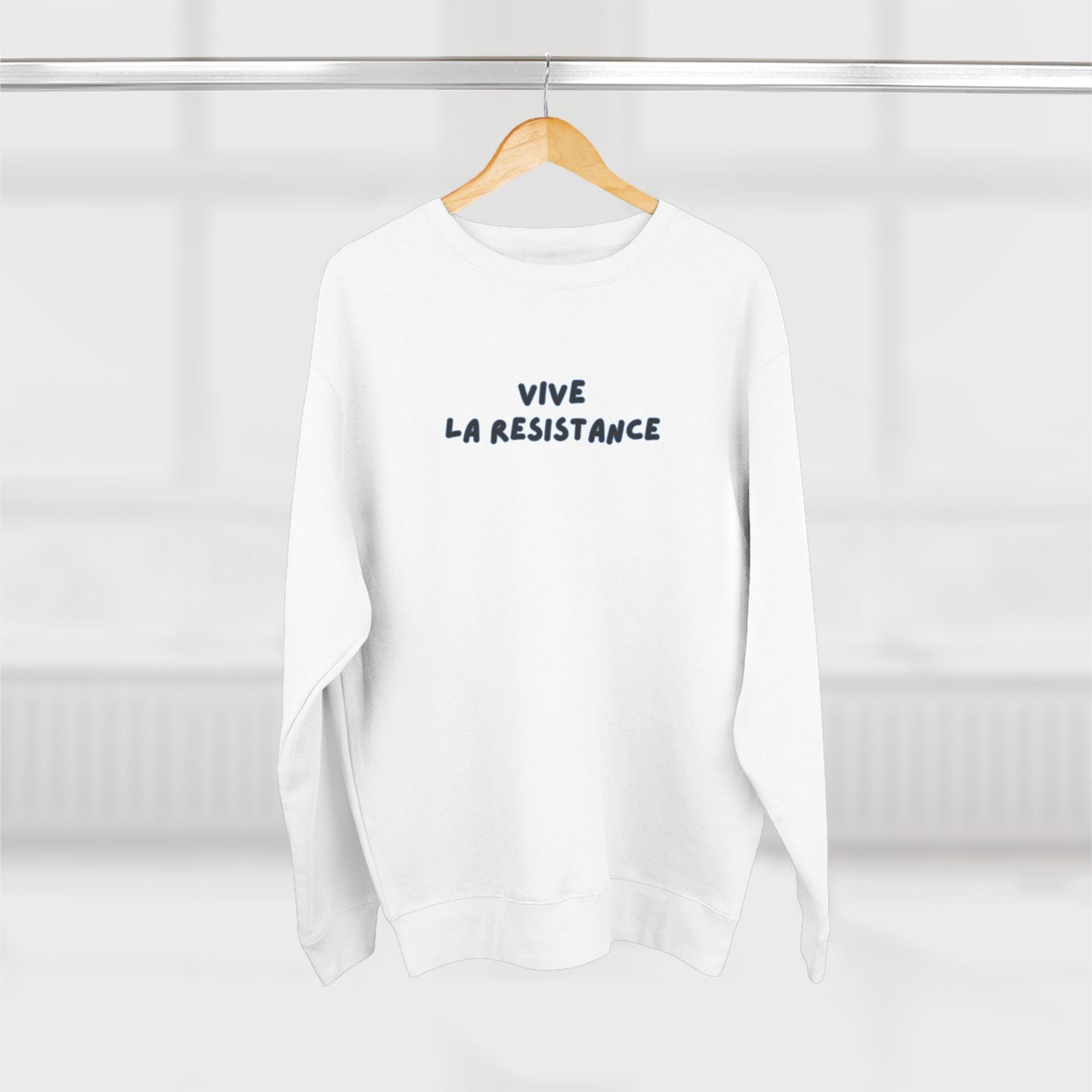 White sweatshirt with 'Vive La Resistance' text on a hanger against a white background