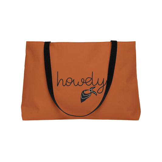 Orange tote bag with 'howdy' and a whale graphic on a white background