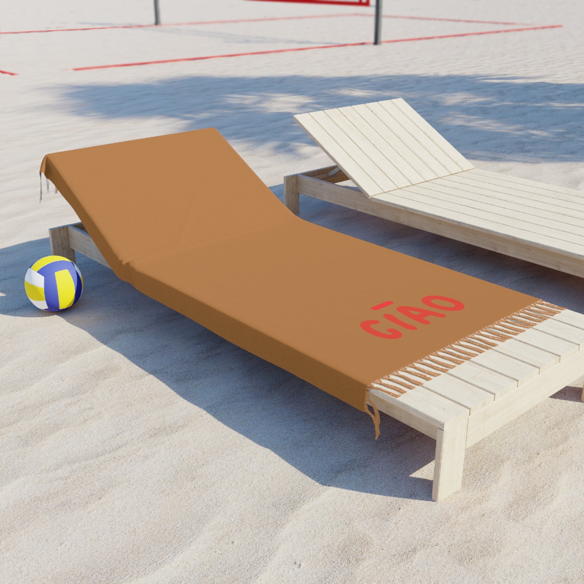 Beach chair with a brown cover labeled 'Cñco' on a sandy surface with a volleyball in the background.