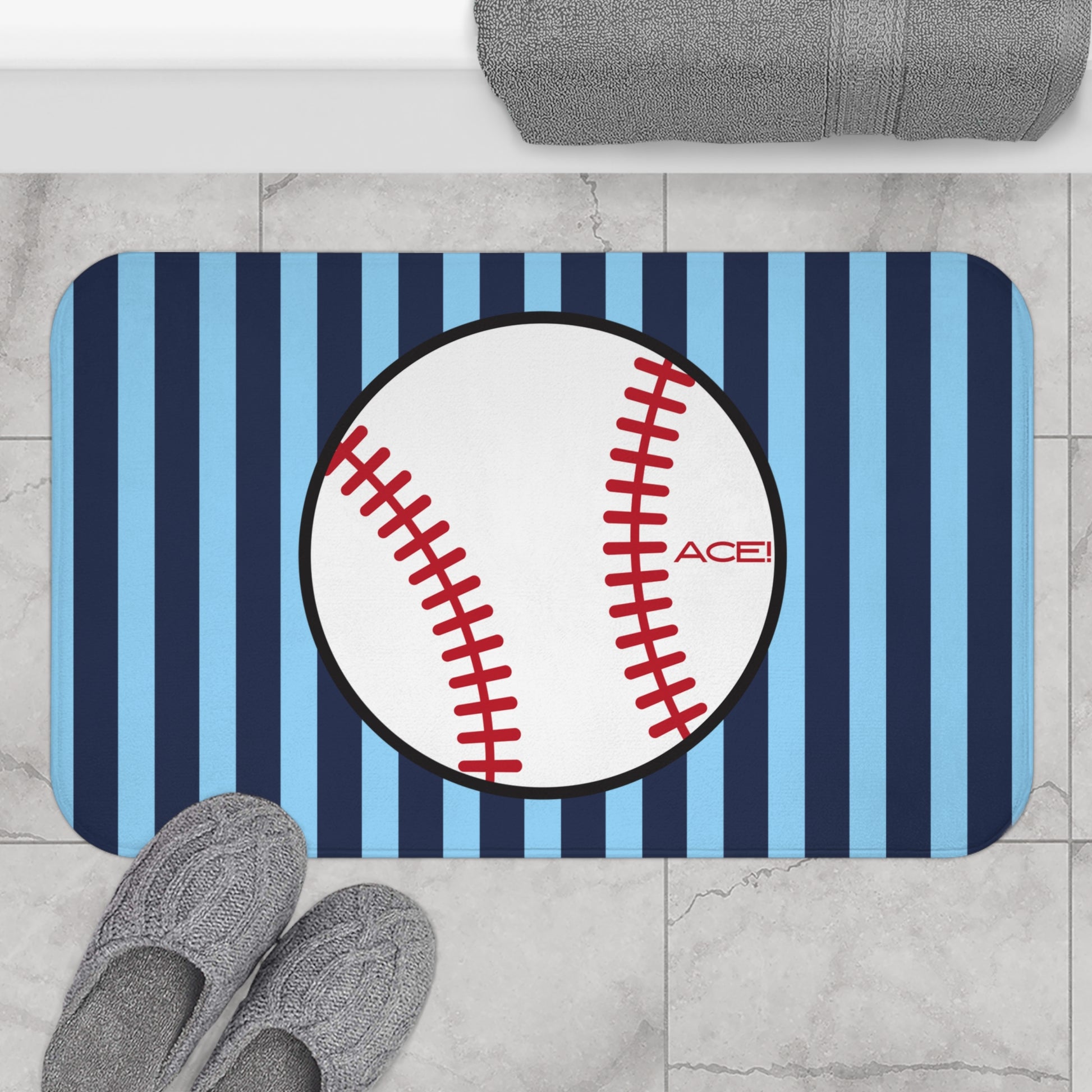 Baseball-themed doormat with blue and white stripes on a tiled floor.