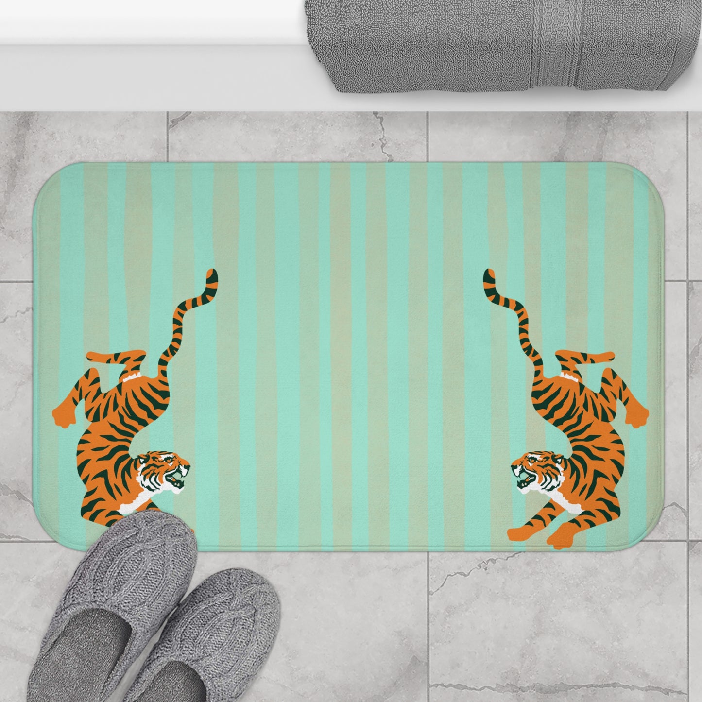 Bath mat with tiger design on a striped background, placed on a tiled floor.