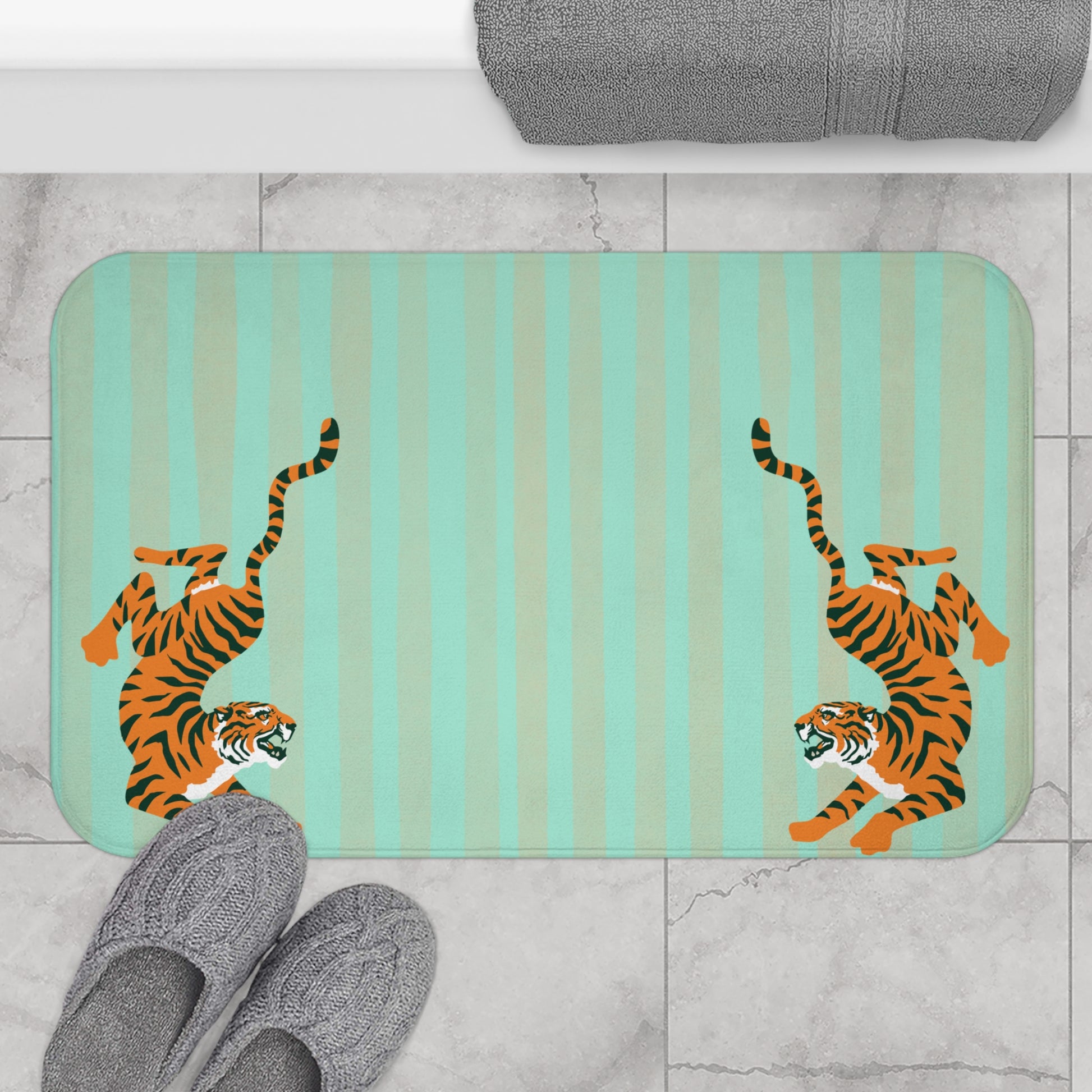 Bath mat with tiger design on a striped background, placed on a tiled floor.