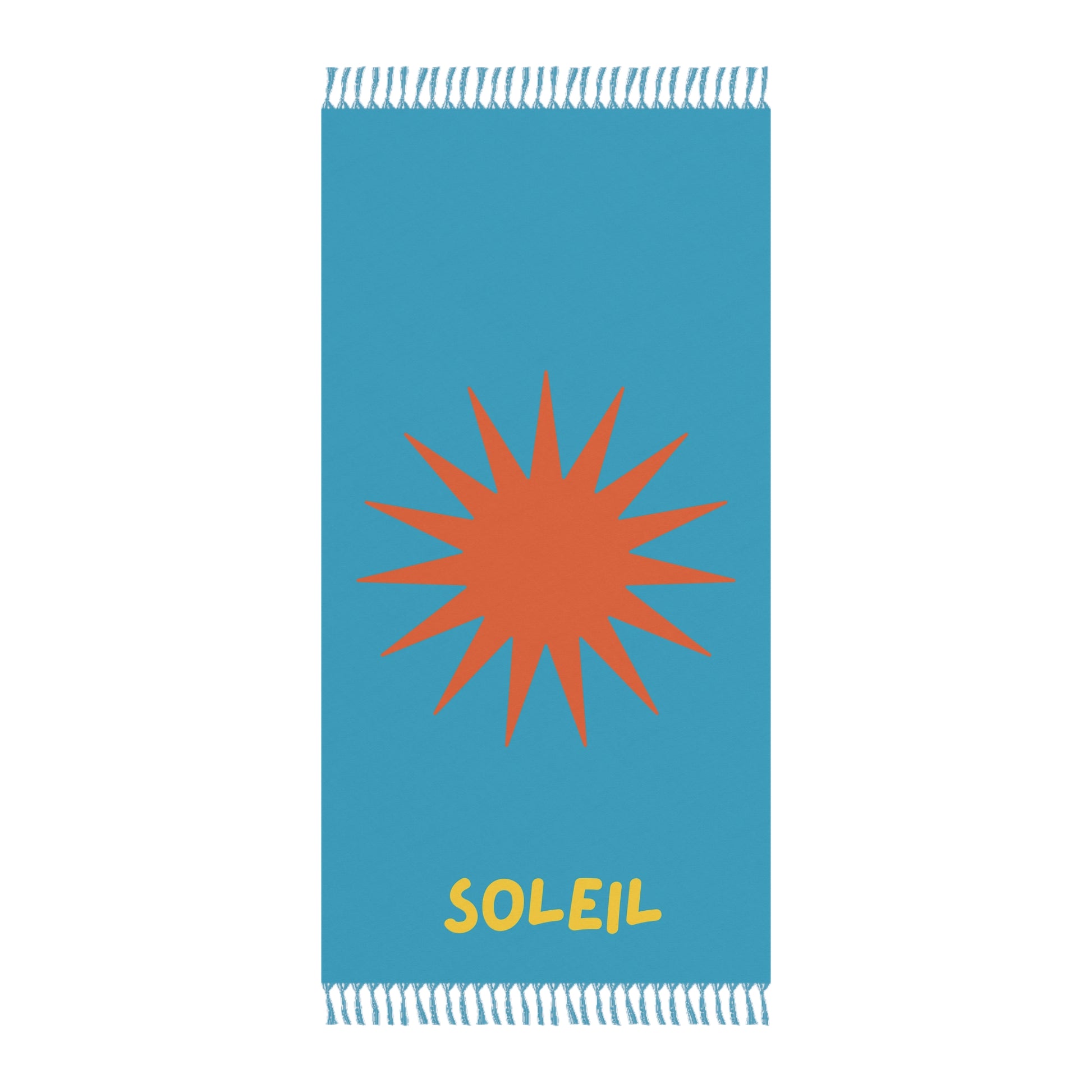 Blue towel with orange sun design and 'Soleil' text on a white background