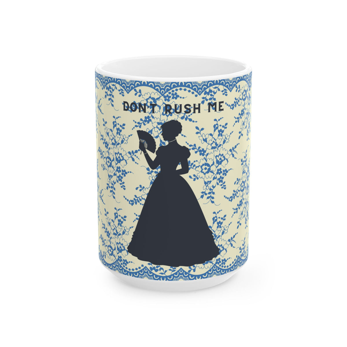 A white ceramic mug featuring a blue floral damask pattern, a black silhouette of a woman in a long dress holding a fan, and the text 'DON'T RUSH ME' in black at the top.