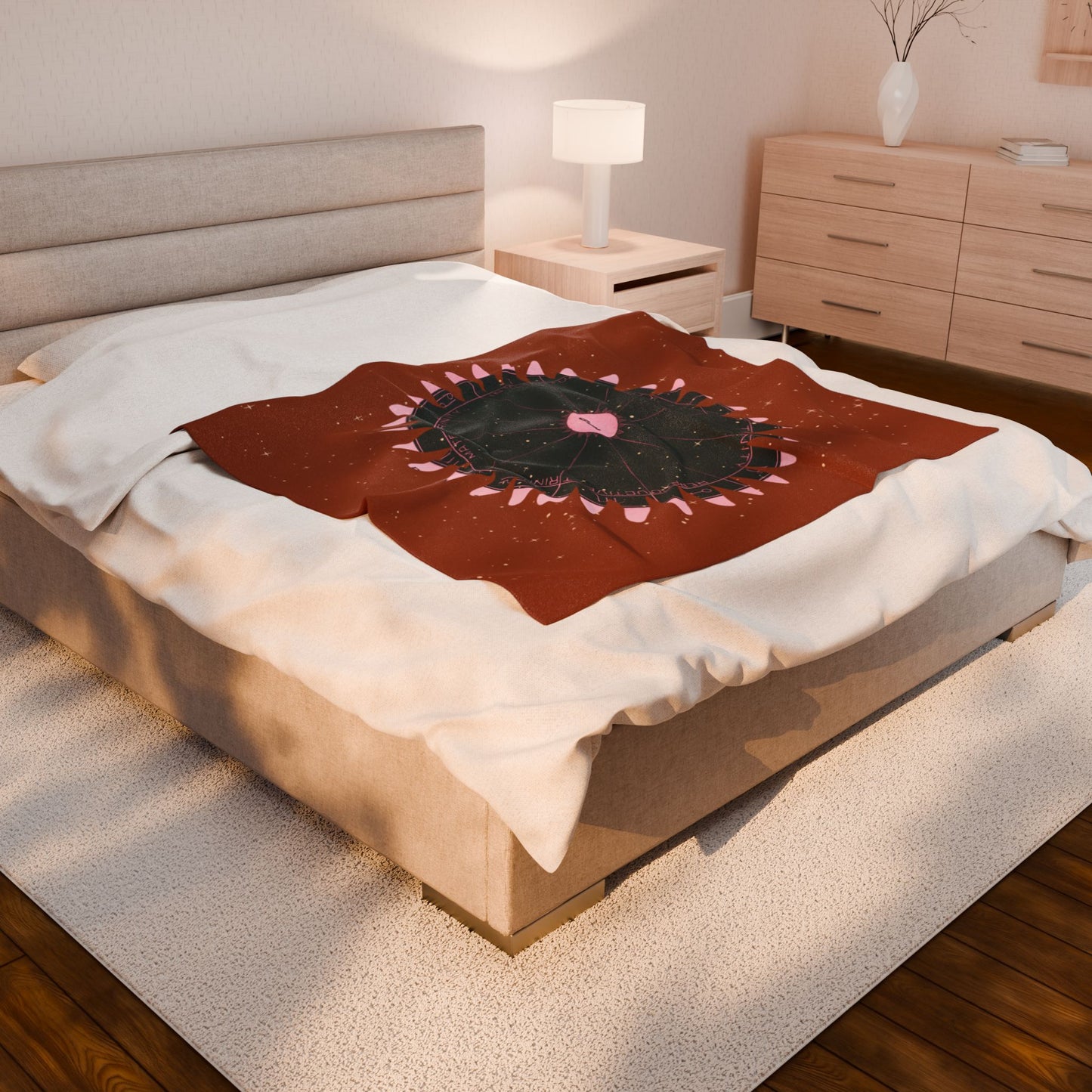 Bedroom with a bed featuring a decorative blanket with a circular design.