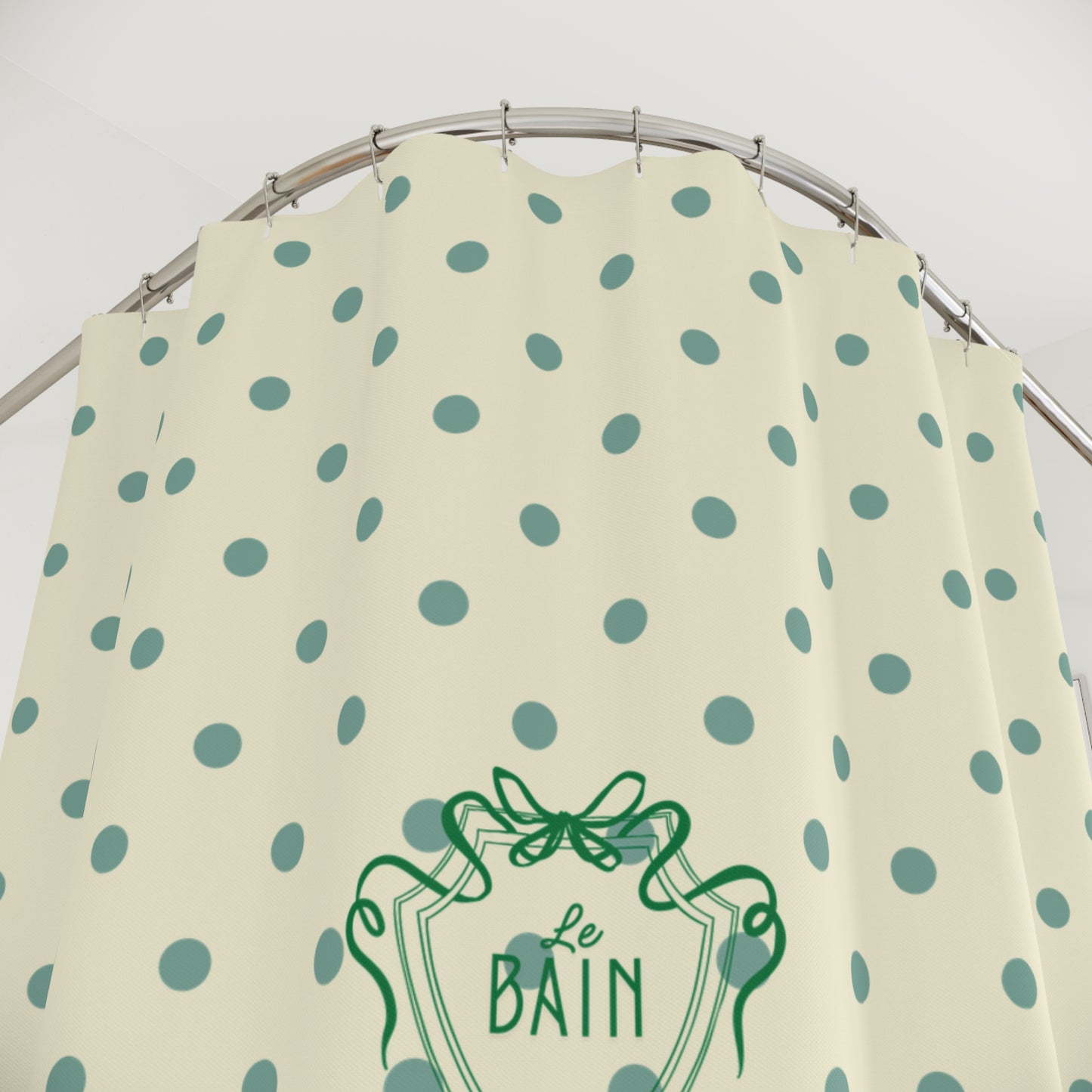 Beige apron with green polka dots and 'Le Bain' logo on a white background