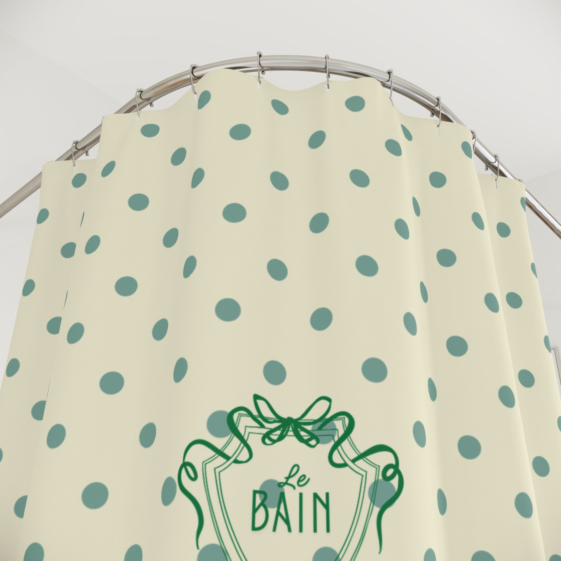 Beige apron with green polka dots and 'Le Bain' logo on a white background