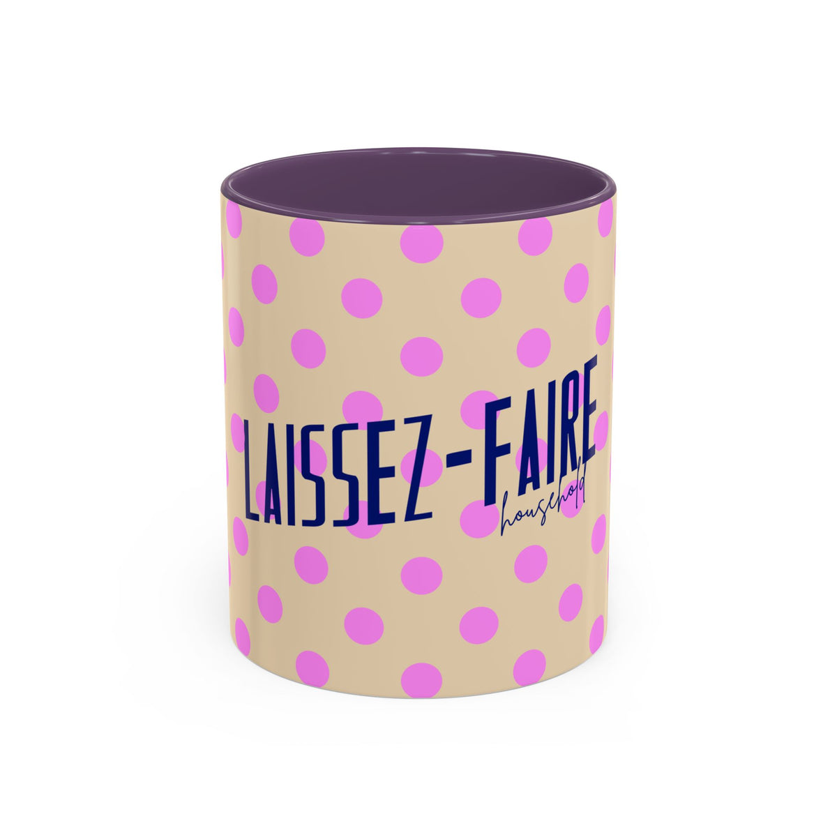 A ceramic mug with a beige exterior decorated with pink polka dots and the French text 'LAISSEZ-FAIRE' in navy blue, featuring a dark purple interior and rim.