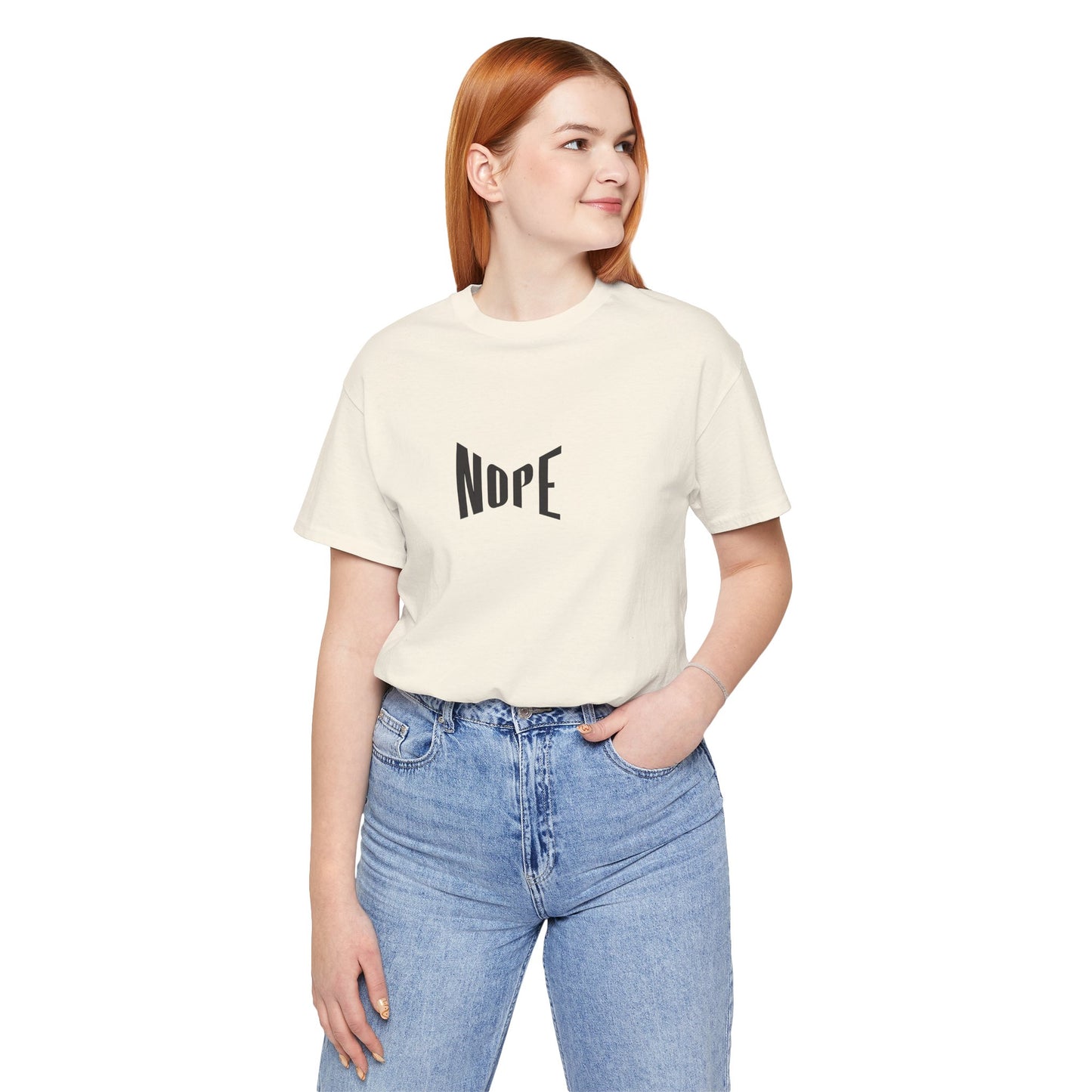 Person wearing a cream t-shirt with 'NDPE' text and blue jeans on a white background