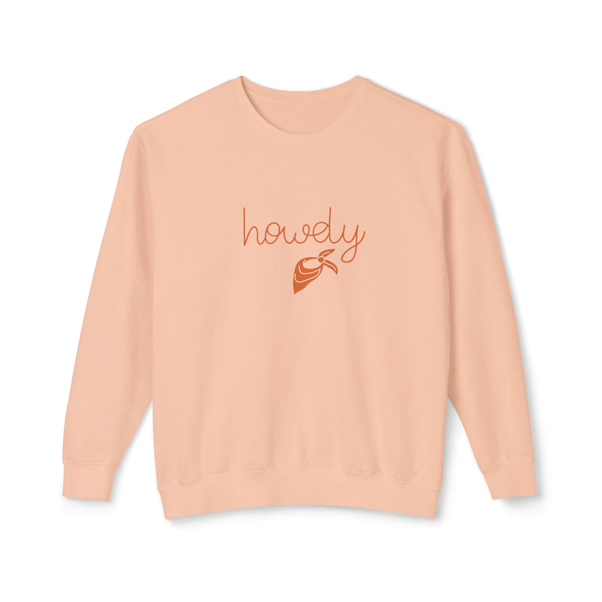 A peach-colored crewneck sweatshirt featuring the word 'howdy' in a cursive orange font above a small orange hot air balloon graphic, displayed on a clean white background.