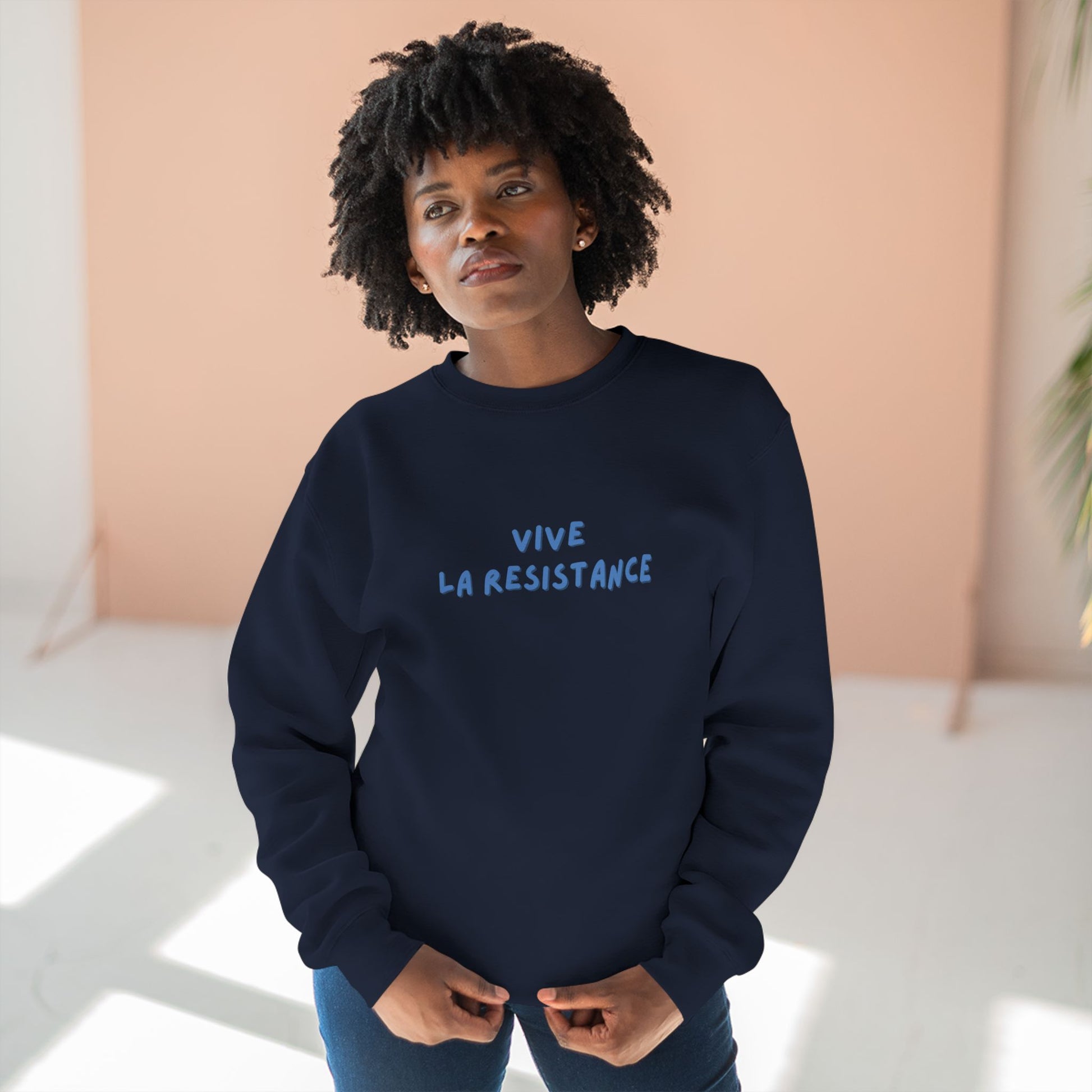 Person wearing a navy sweatshirt with 'Vive La Resistance' text against a light background