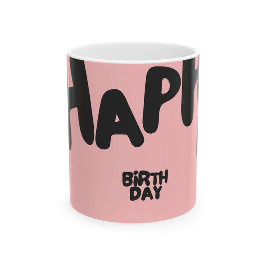 Pink mug with black text spelling 'HAPPY BIRTHDAY' on a white background