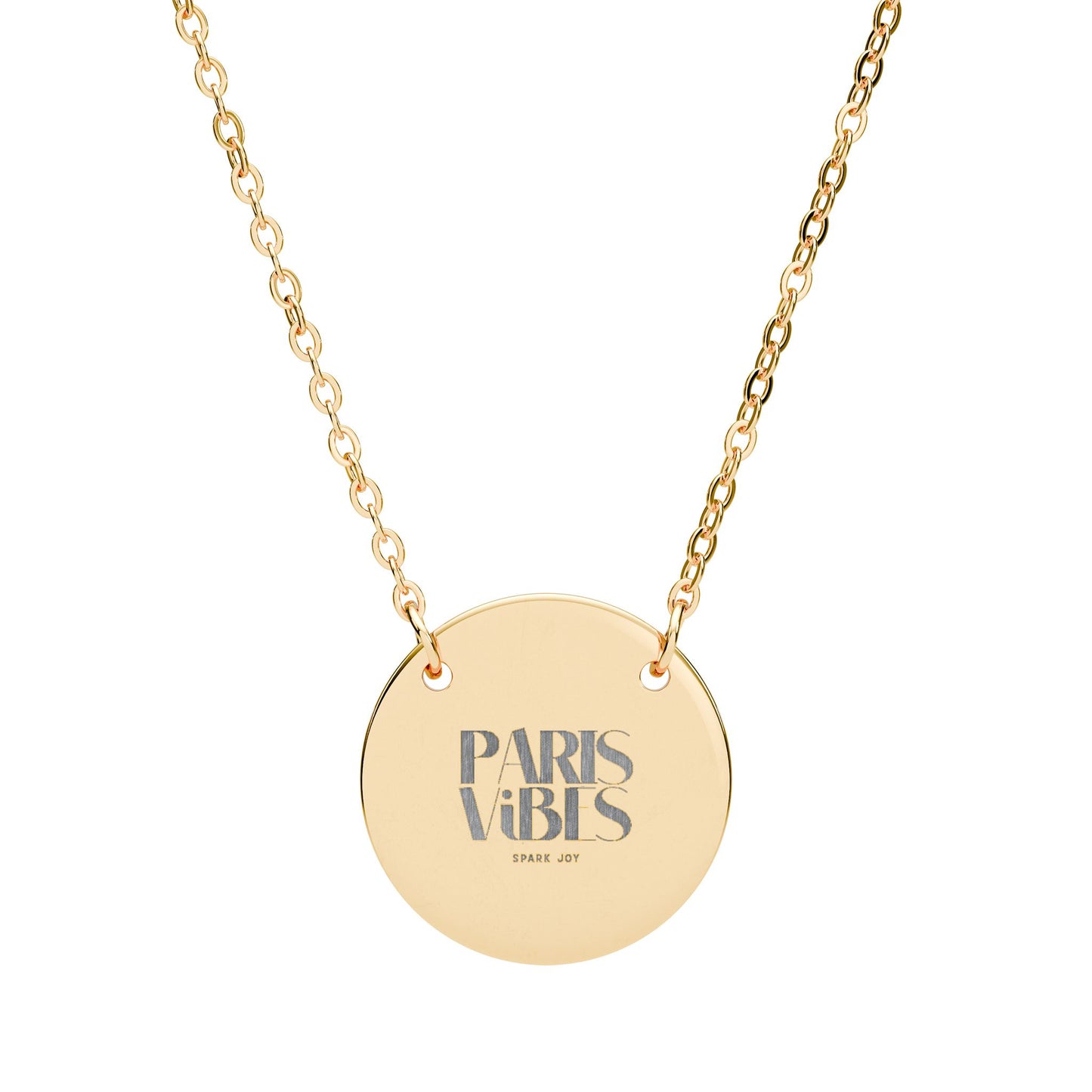 Gold necklace with a round pendant that says 'Paris Vibes' on a white background
