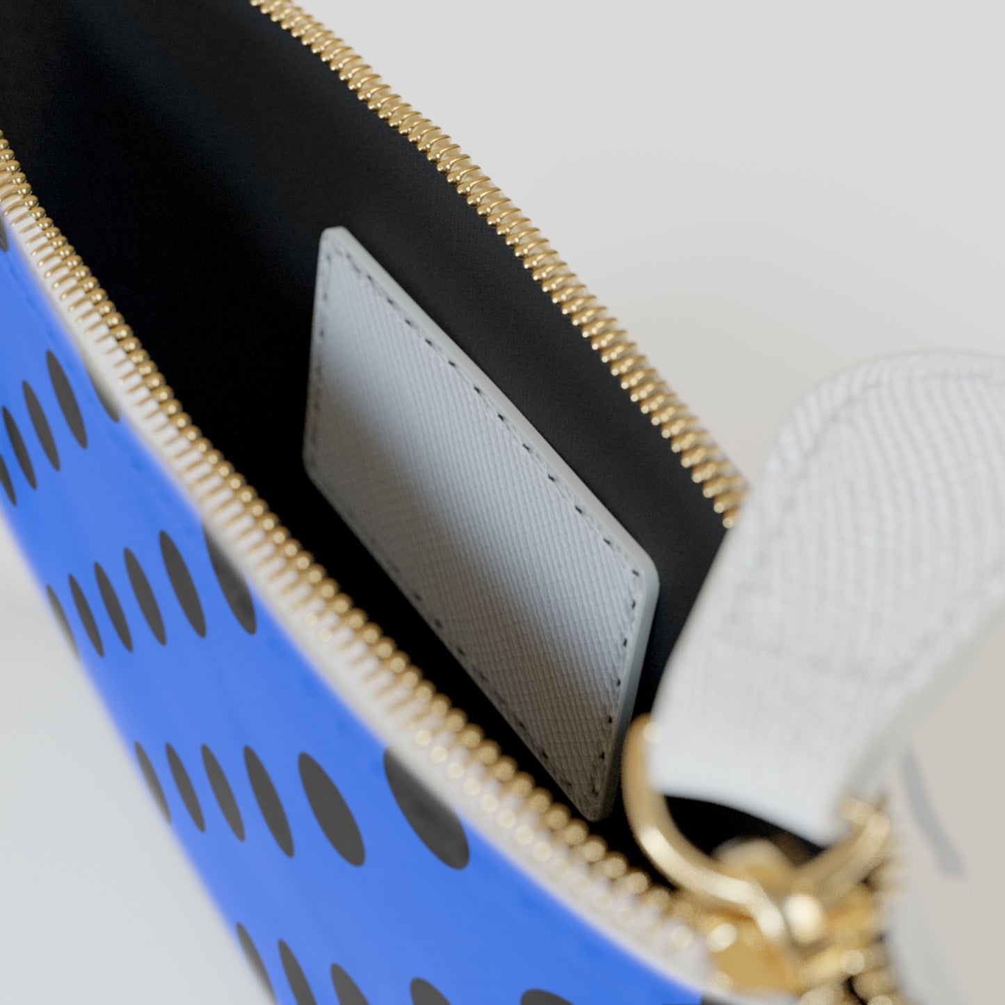Close-up of a blue basket with a gold handle and black interior.