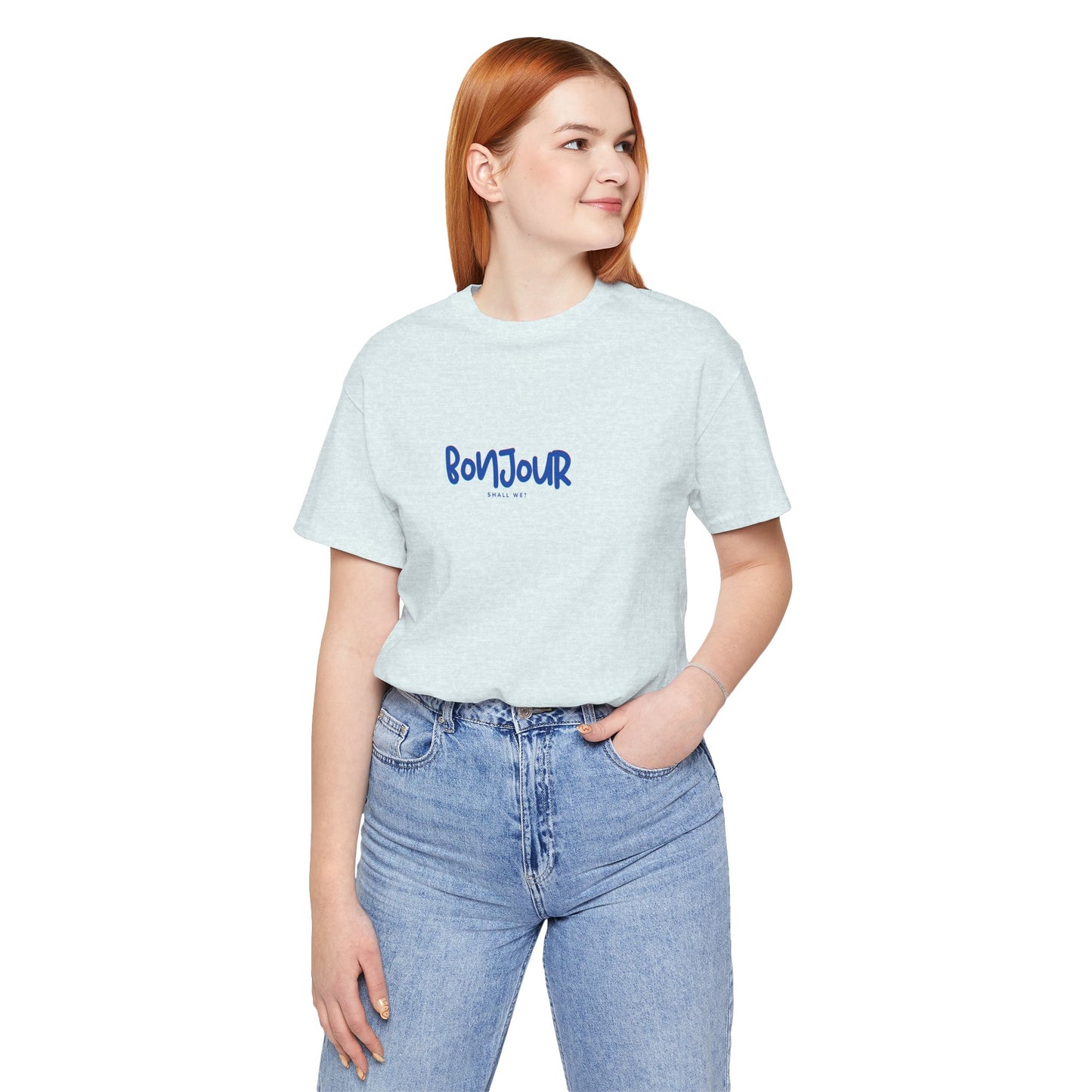 Person wearing a light blue t-shirt with text and jeans on a white background