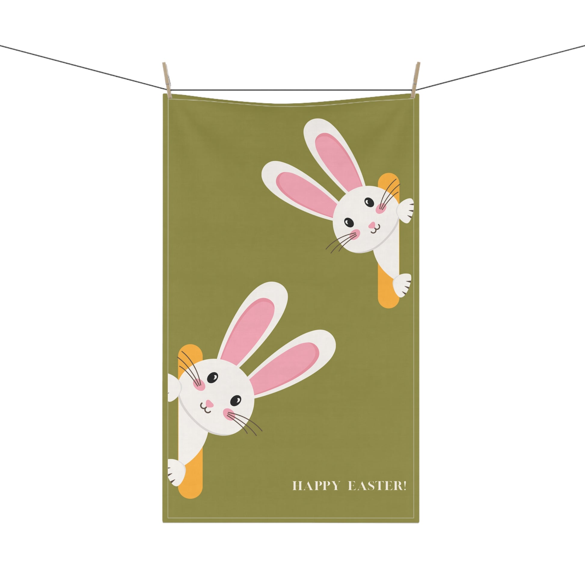 Green towel with cartoon bunnies and 'Happy Easter!' text hanging on a line.
