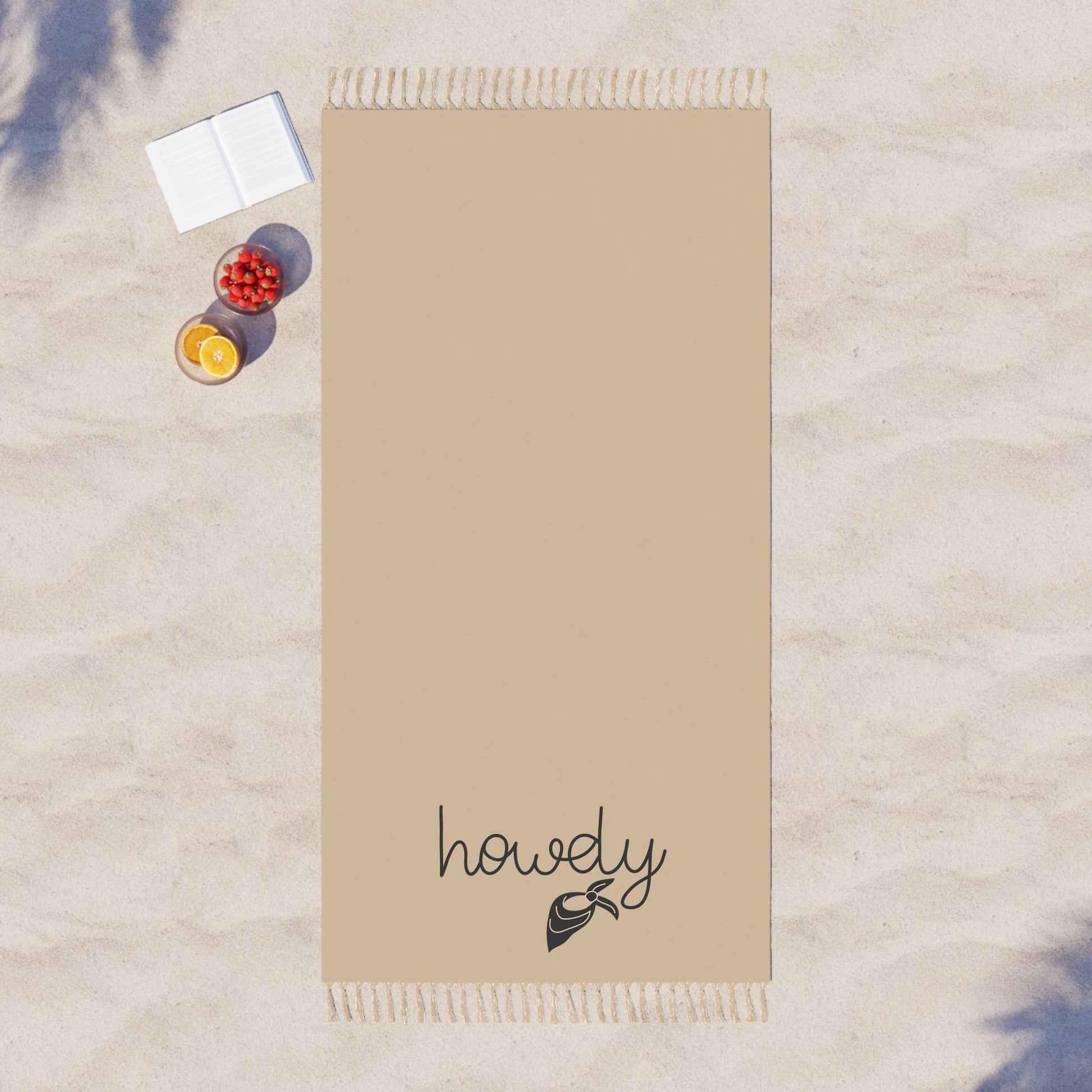 Beige towel with 'howdy' text on a textured surface
