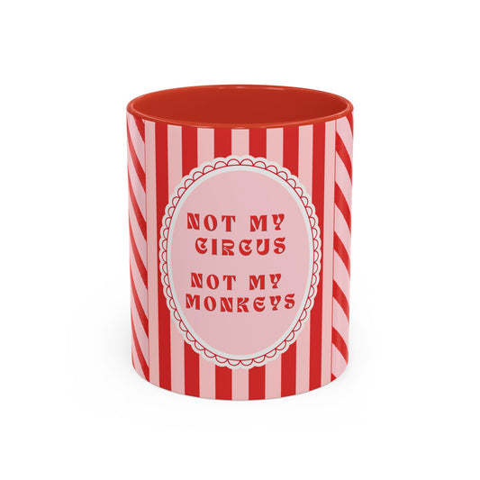 A red and white striped ceramic mug with a pink circular label in the center that reads 'NOT MY CIRCUS NOT MY MONKEYS' in red text.