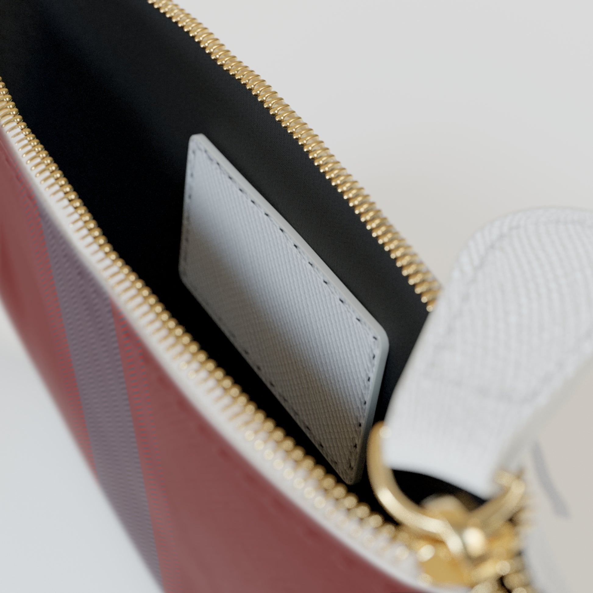 Close-up of a handbag with gold zipper and interior details.