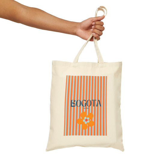 Tote bag with 'Bogota' and flower design held by a hand on a white background