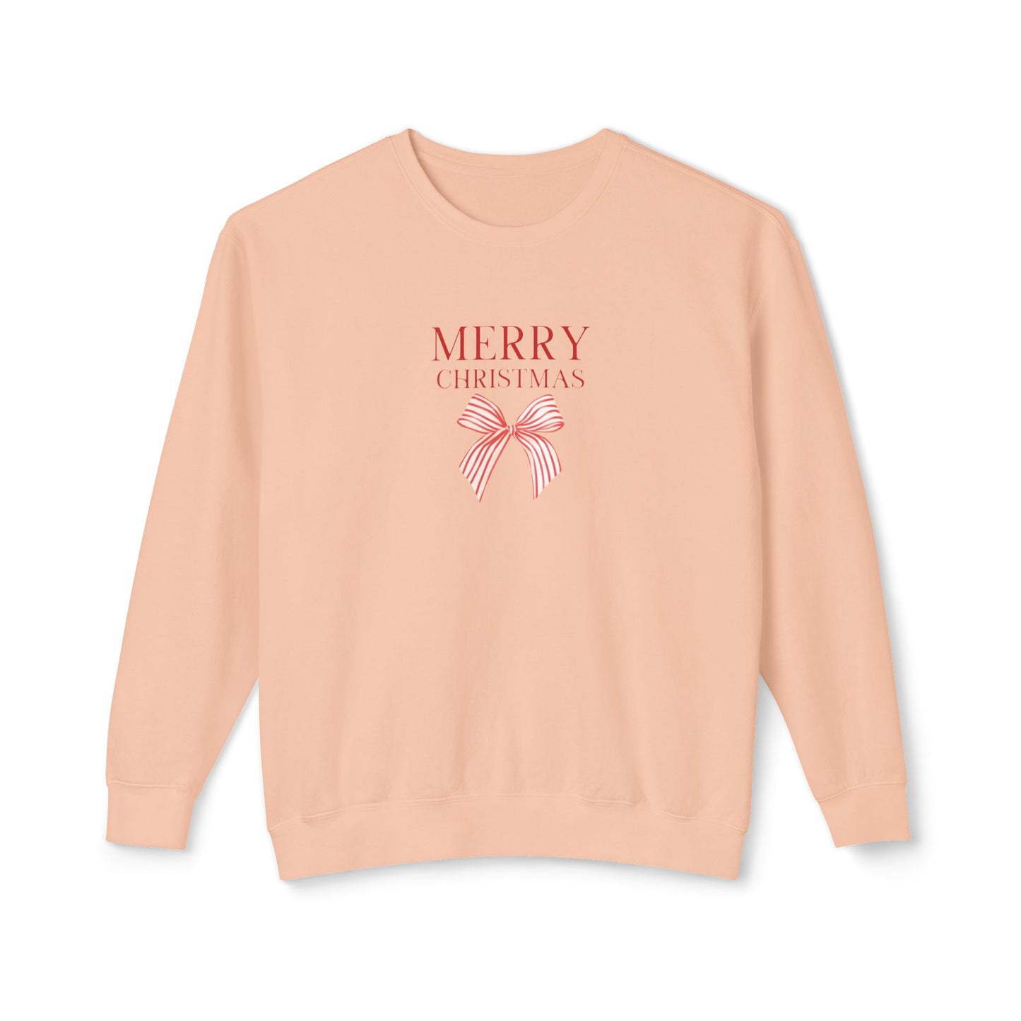 A peach-colored crewneck sweatshirt featuring a 'MERRY CHRISTMAS' graphic with a red and white striped bow on the chest, displayed against a clean white background.